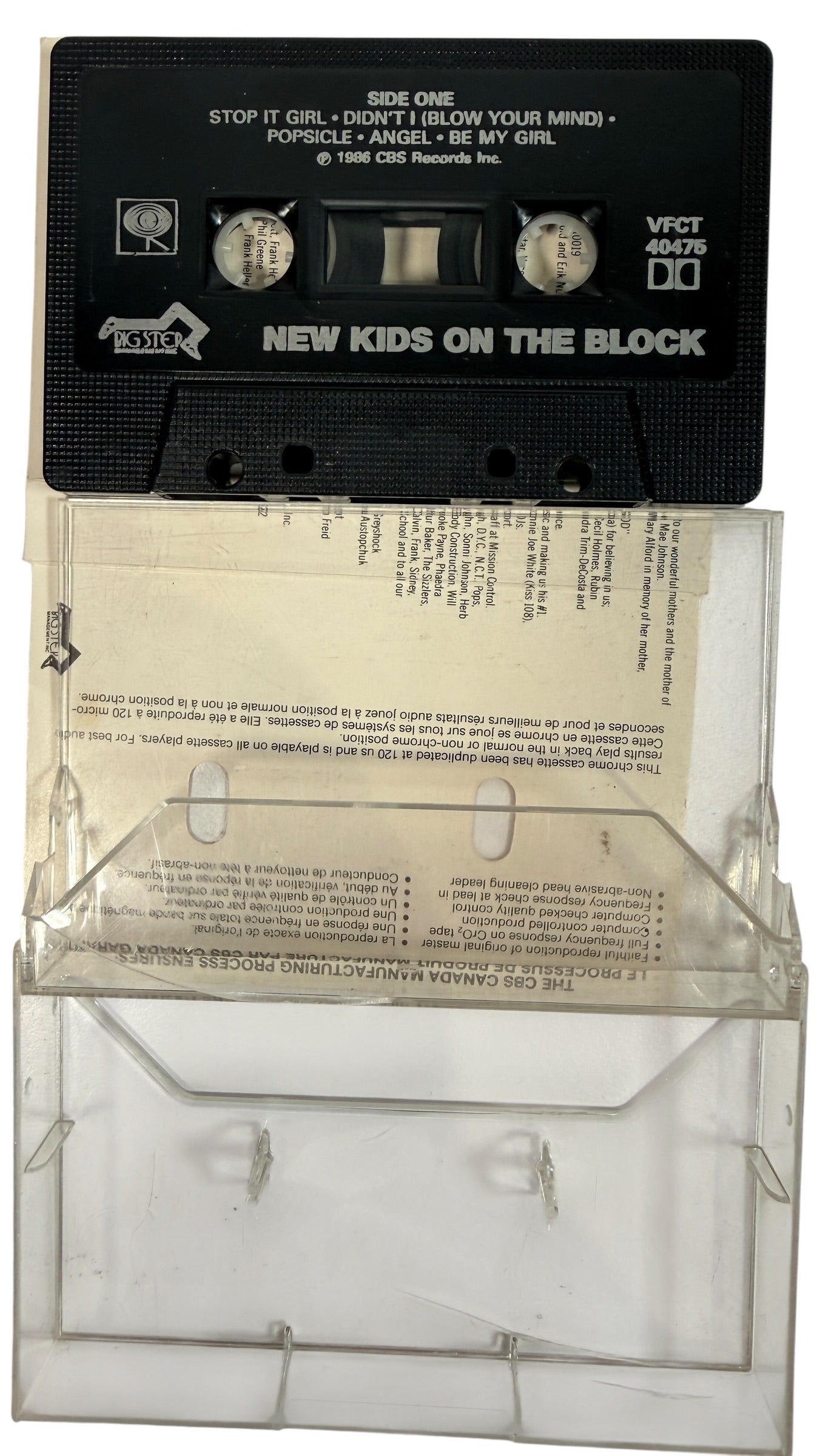 Cassette tape with clear plastic cover featuring text, on a white background