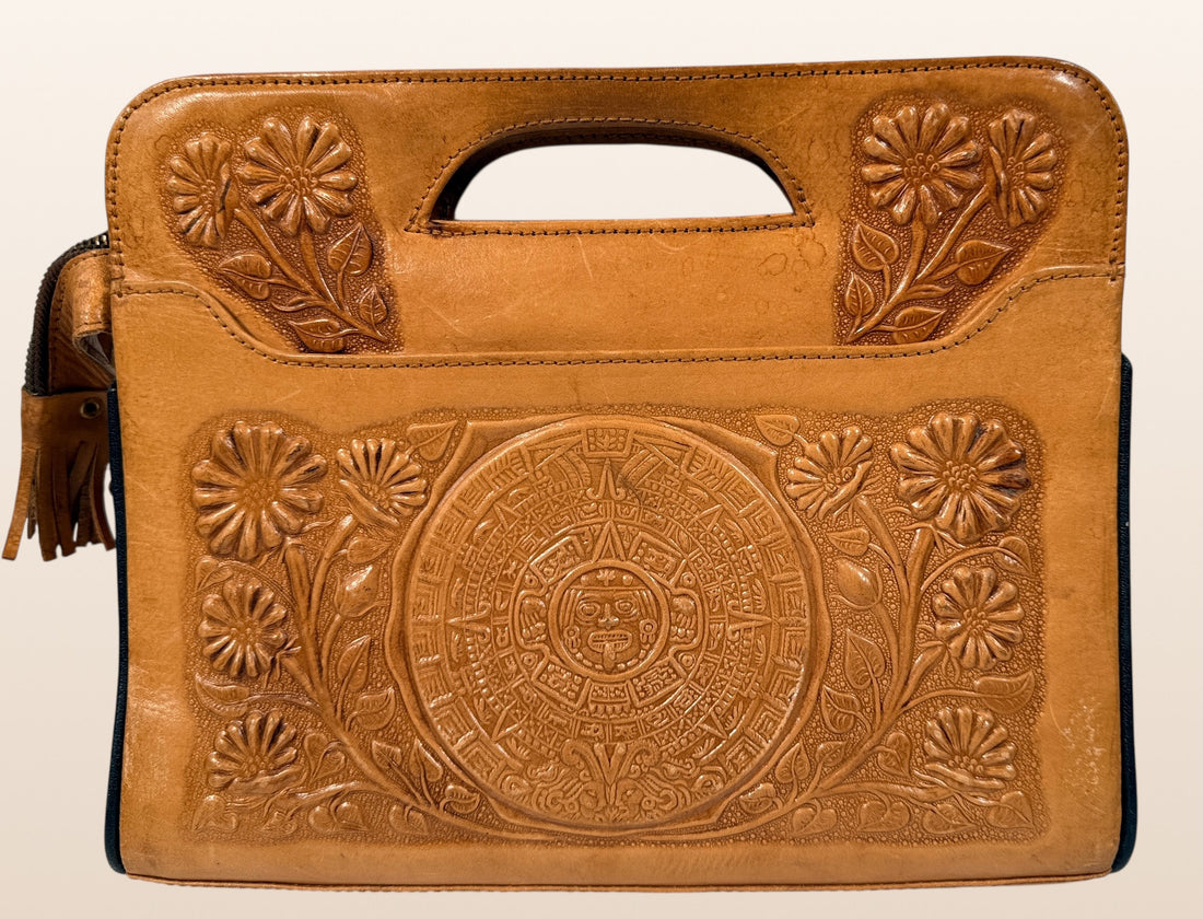 Vintage Mexican tooled leather handbag with Aztec calendar motif, floral embossing, detachable strap, classic artisan leather purse with strong vintage appeal.