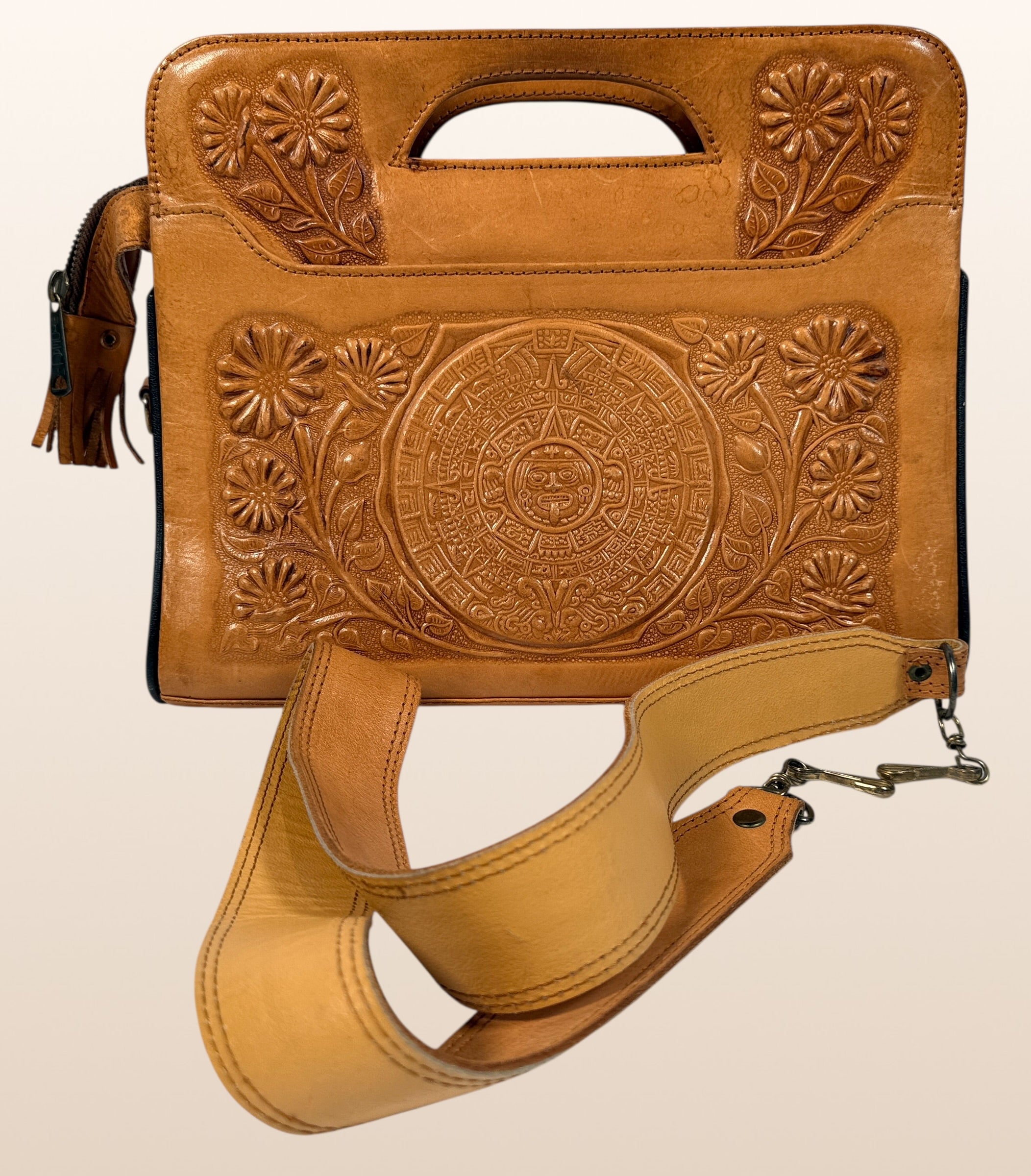 Vintage Mexican tooled leather handbag with Aztec calendar motif, floral embossing, detachable strap, classic artisan leather purse with strong vintage appeal.
