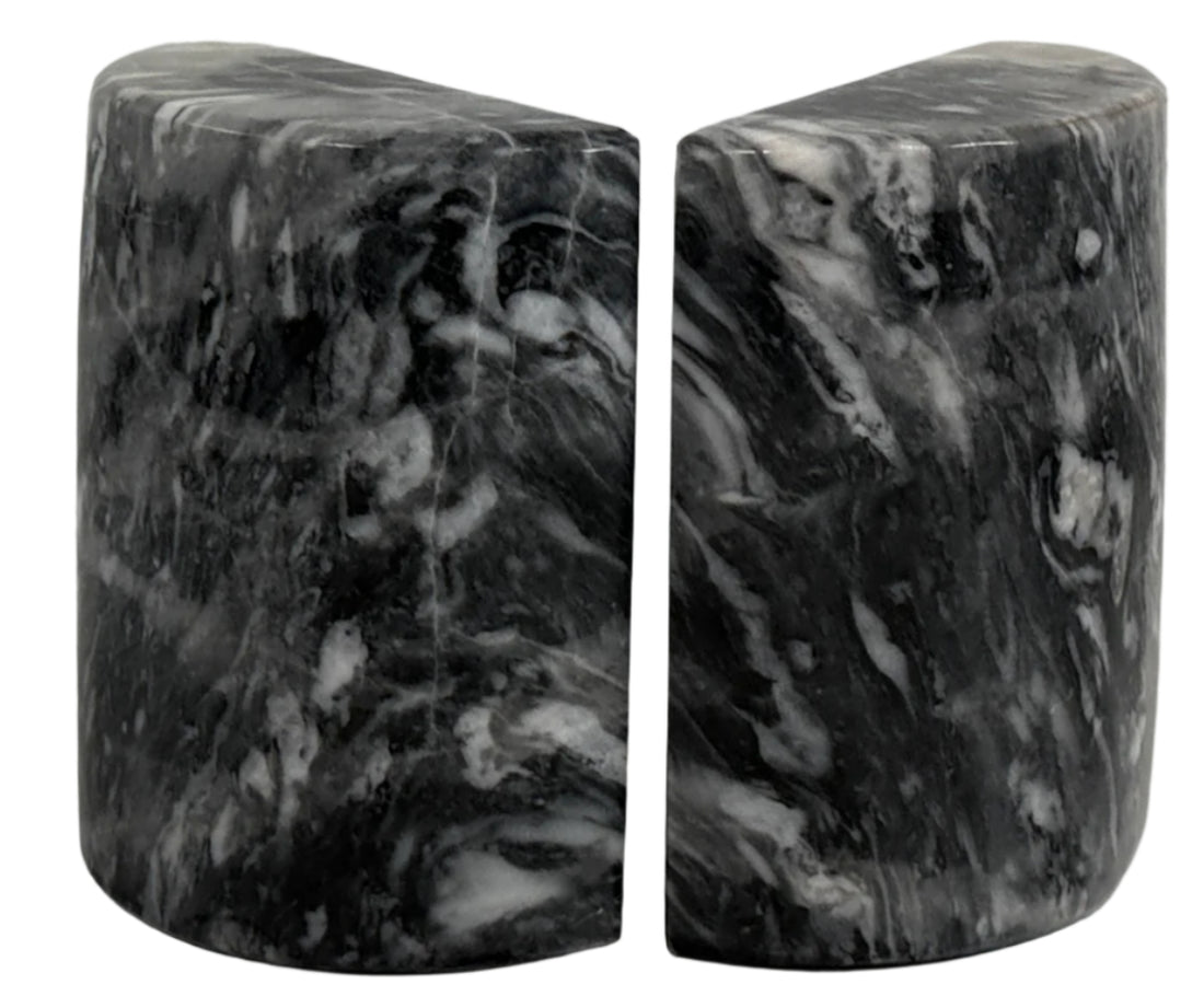 Marble bookends on a white surface with a light gray background