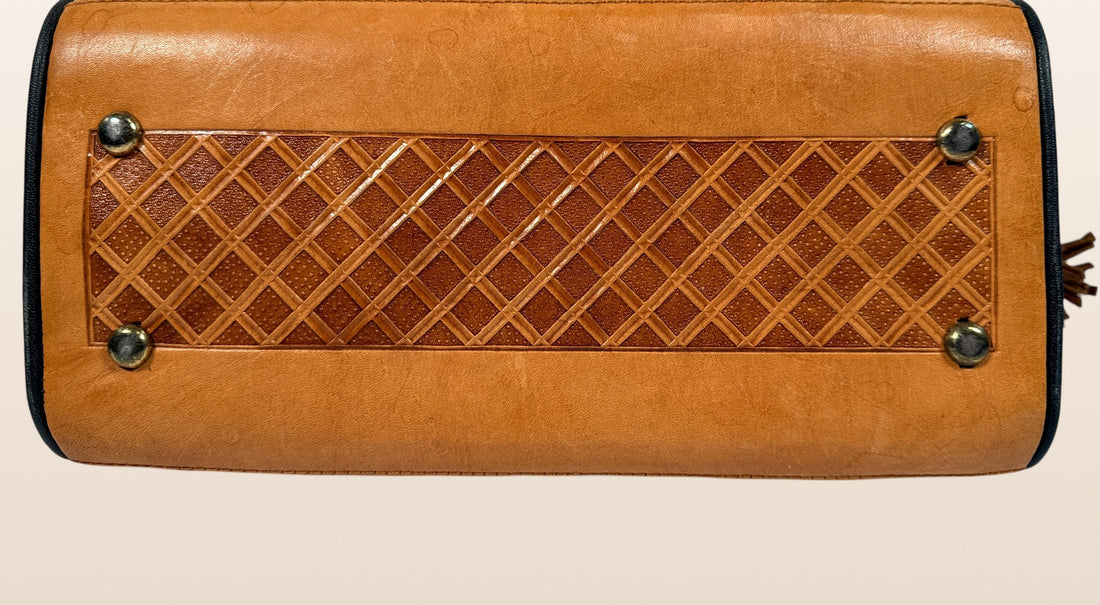 Vintage Mexican tooled leather handbag with Aztec calendar motif, floral embossing, detachable strap, classic artisan leather purse with strong vintage appeal.