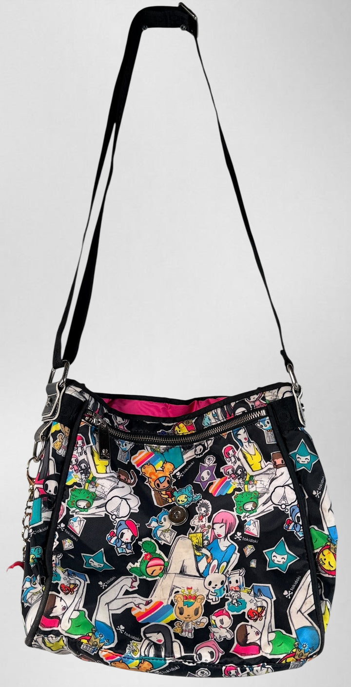 Tokidoki graphic nylon shoulder bag with character print, pink lining and charm. Designer streetwear purse in great condition, collectible fashion accessory.