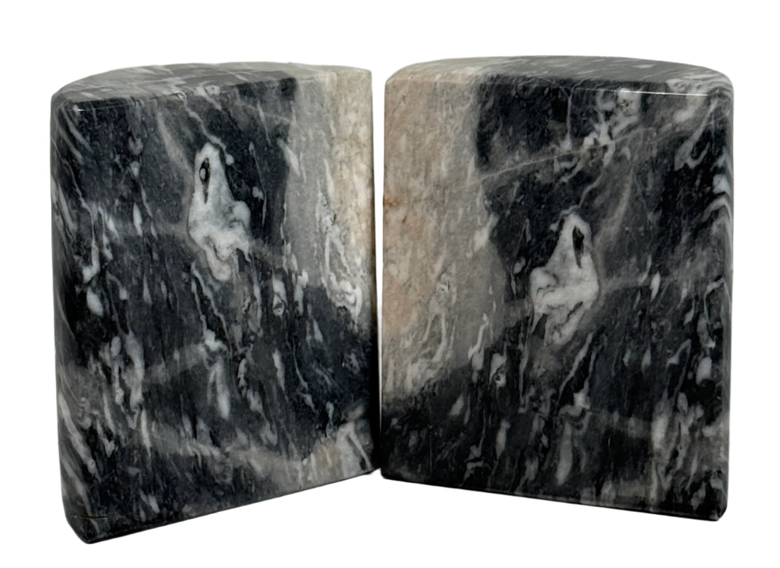 Two marble bookends with a gray and black marbled pattern on a light gray background.