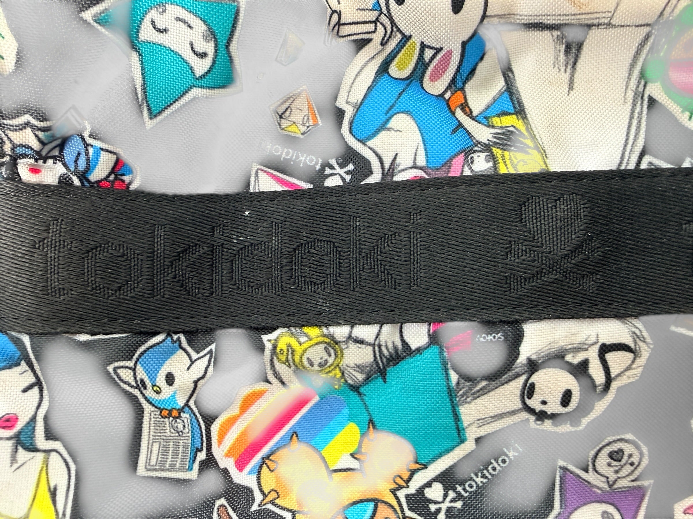 Tokidoki graphic nylon shoulder bag with character print, pink lining and charm. Designer streetwear purse in great condition, collectible fashion accessory.