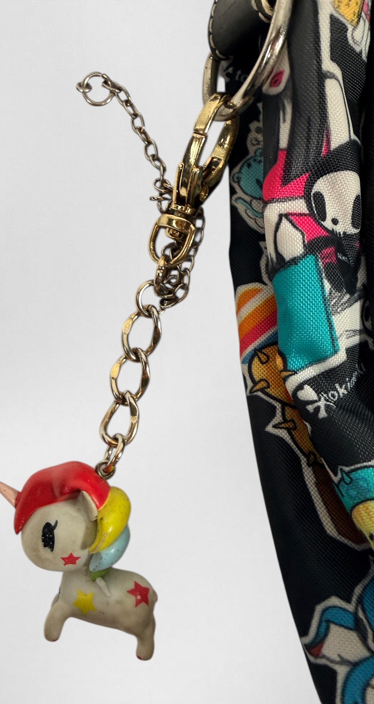 Tokidoki graphic nylon shoulder bag with character print, pink lining and charm. Designer streetwear purse in great condition, collectible fashion accessory.