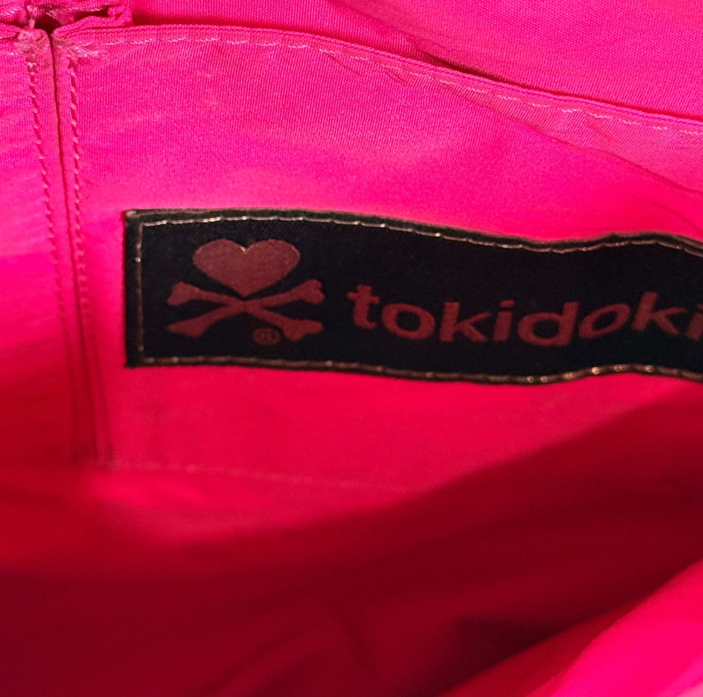 Tokidoki graphic nylon shoulder bag with character print, pink lining and charm. Designer streetwear purse in great condition, collectible fashion accessory.