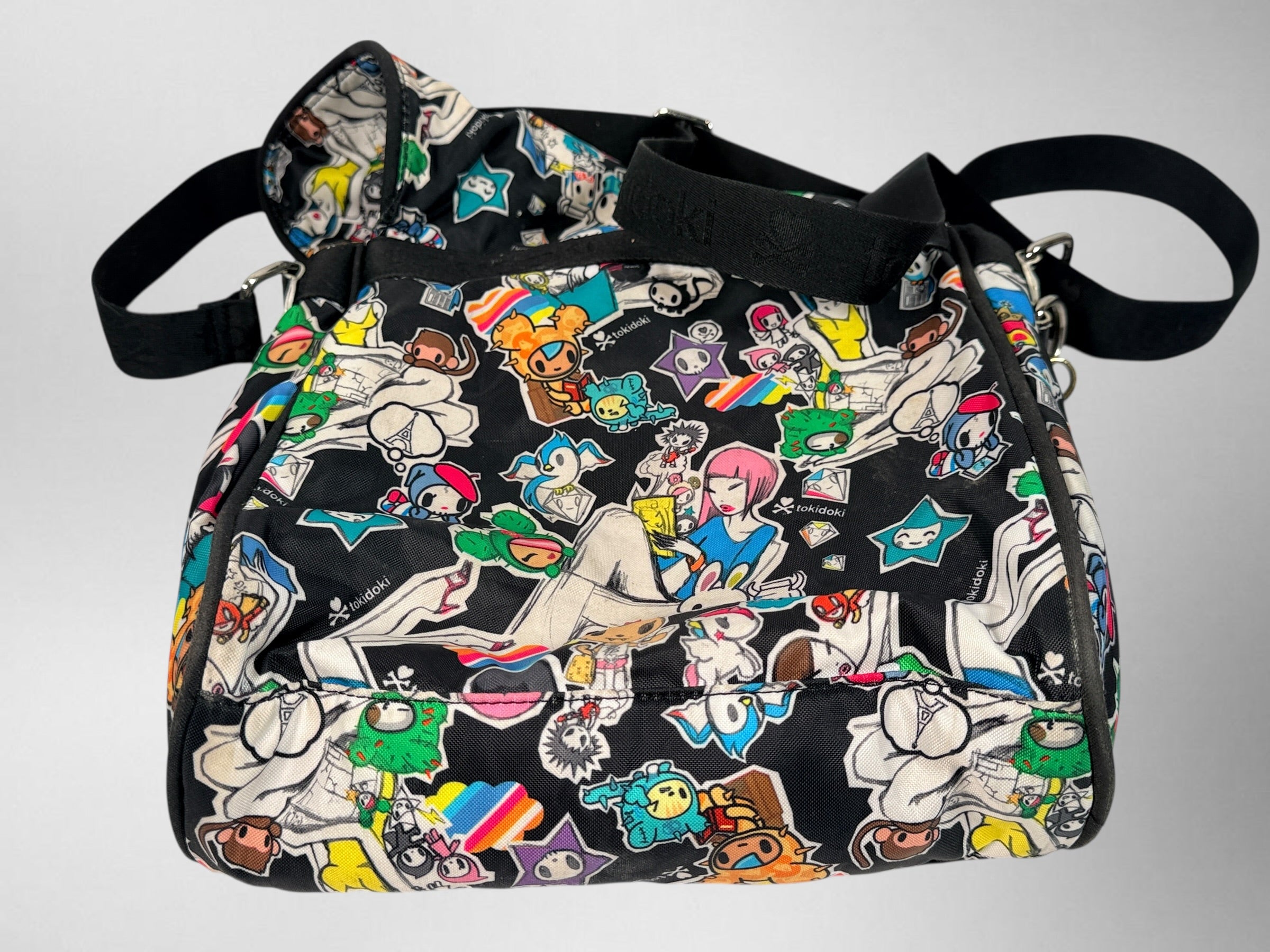 Tokidoki graphic nylon shoulder bag with character print, pink lining and charm. Designer streetwear purse in great condition, collectible fashion accessory.