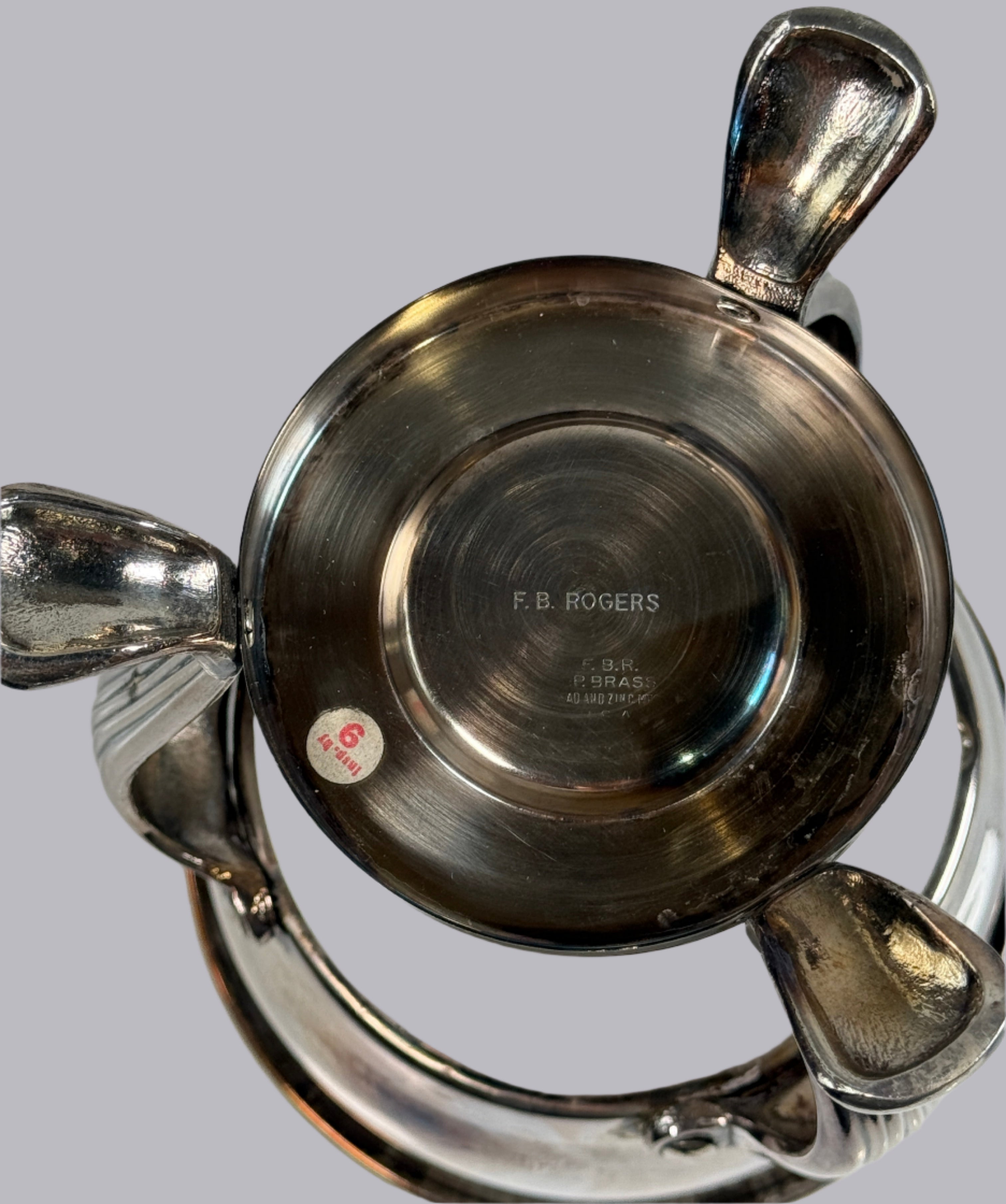 Close-up of a silver bowl with 'F.B. Rogers' branding on a white background