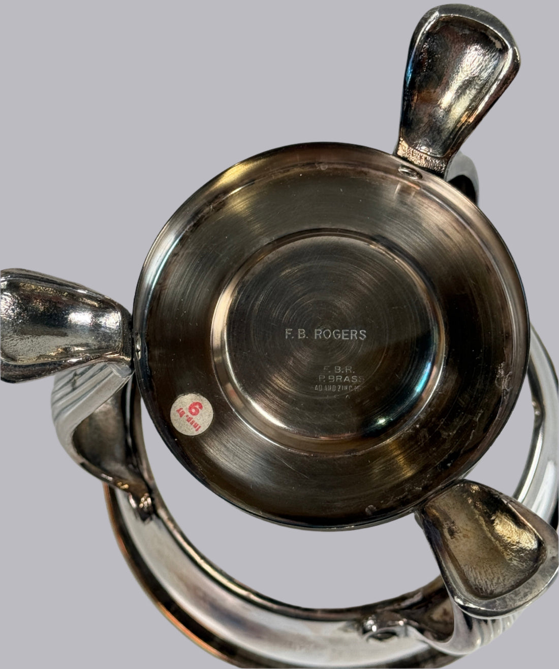 Close-up of a silver bowl with 'F.B. Rogers' branding on a white background