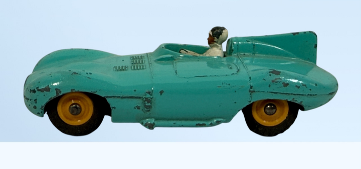 Vintage Dinky Toys #238 Jaguar D-Type racing car in turquoise. Original Meccano Ltd. die-cast model, made in England, with authentic playwear.