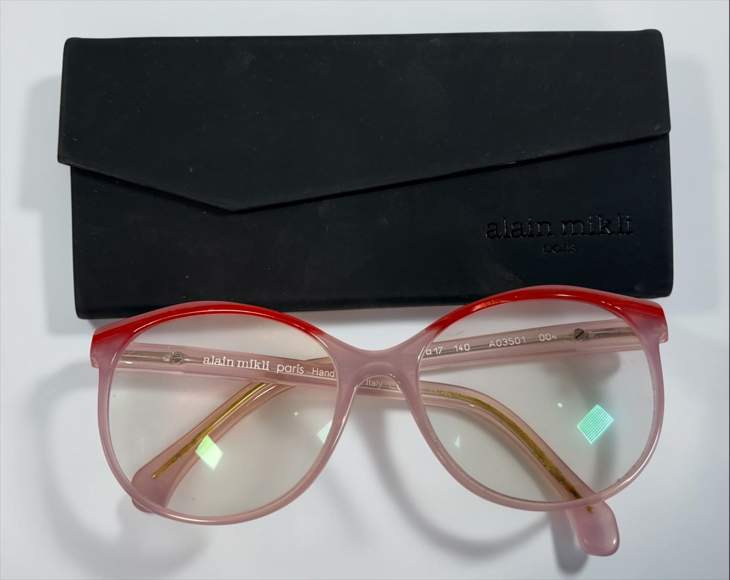 Alain Mikli A03501 004 eyeglass frame in pink and red acetate, handmade in Italy, size 54-17-140. Pre-owned with original Alain Mikli case.