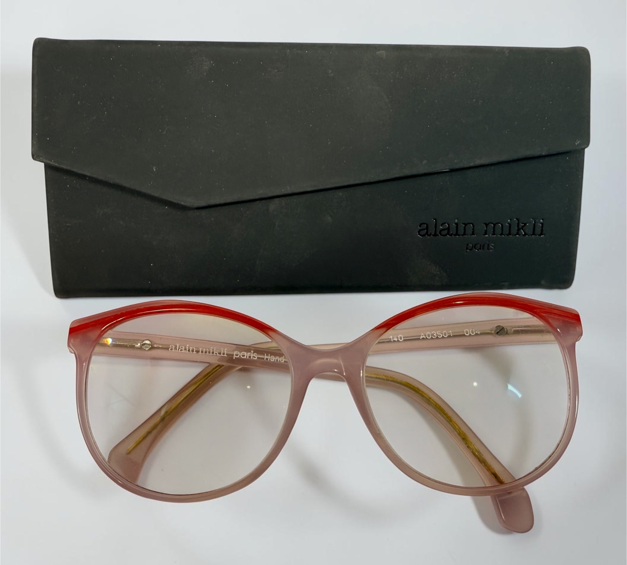 Alain Mikli A03501 004 eyeglass frame in pink and red acetate, handmade in Italy, size 54-17-140. Pre-owned with original Alain Mikli case.