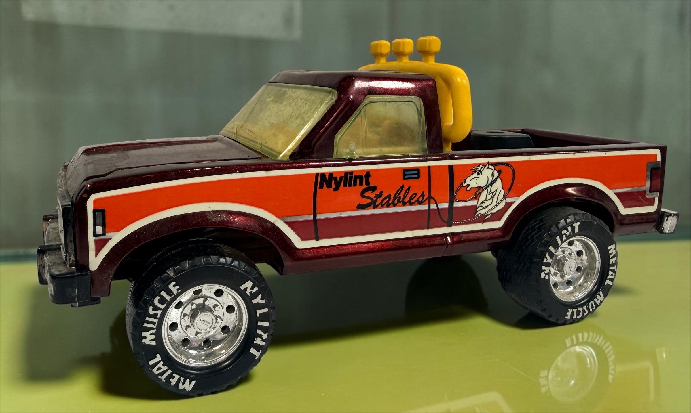 Vintage Nylint Stables Metal Muscle pressed-steel pickup truck, made in Rockford, Illinois, USA. Classic 1980s collectible toy with horse graphics.