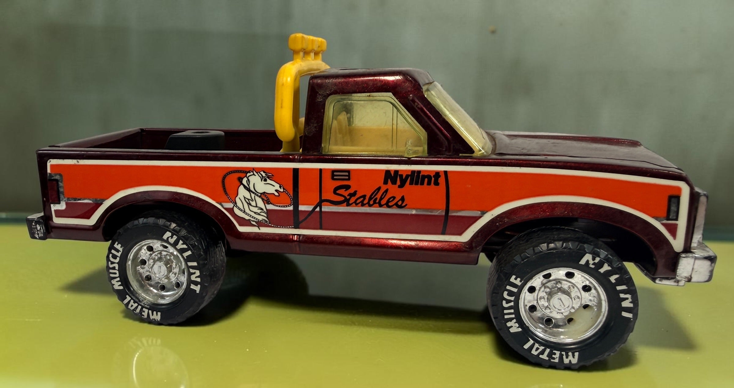 Vintage Nylint Stables Metal Muscle pressed-steel pickup truck, made in Rockford, Illinois, USA. Classic 1980s collectible toy with horse graphics.