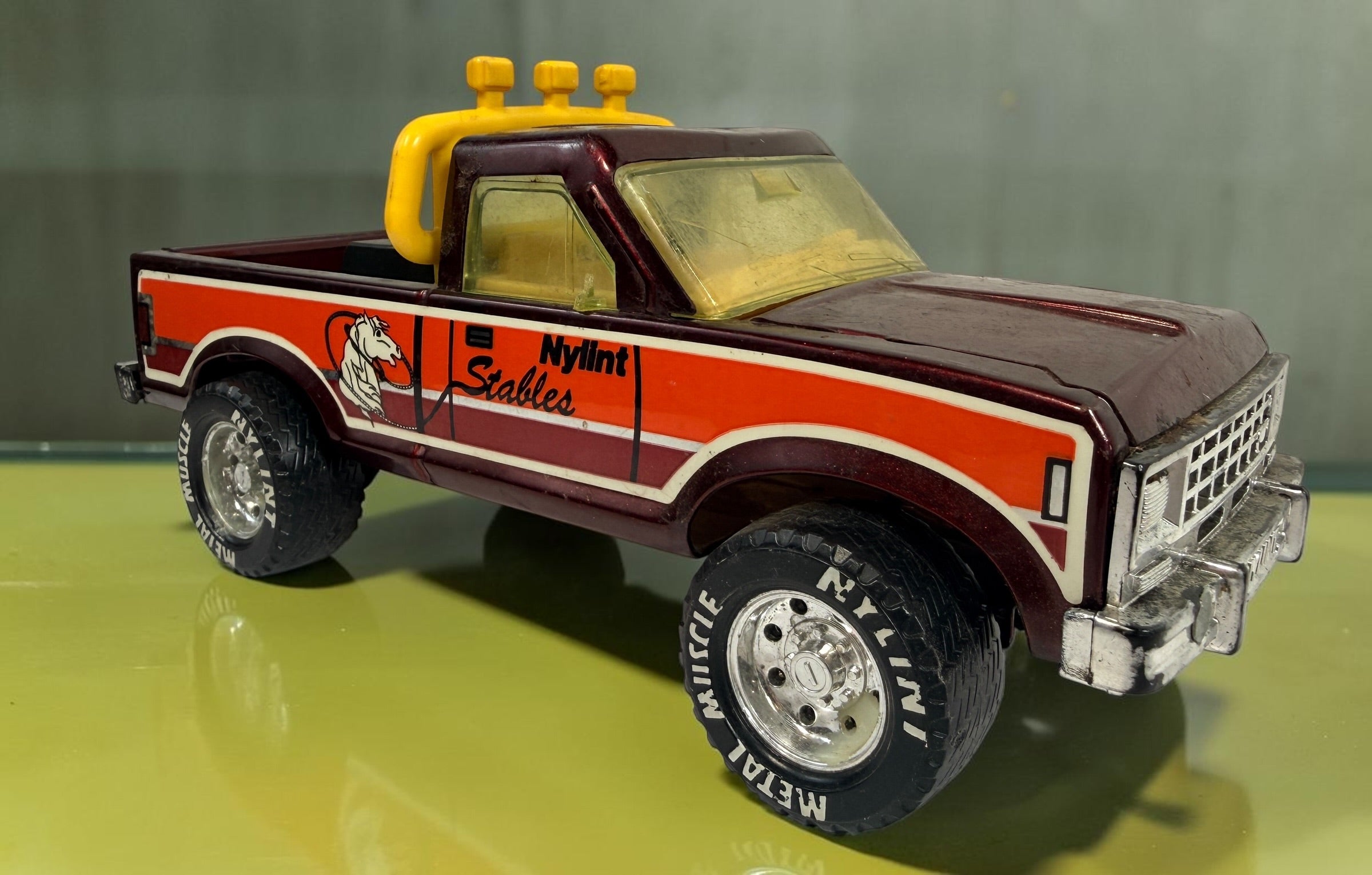 Vintage Nylint Stables Metal Muscle pressed-steel pickup truck, made in Rockford, Illinois, USA. Classic 1980s collectible toy with horse graphics.