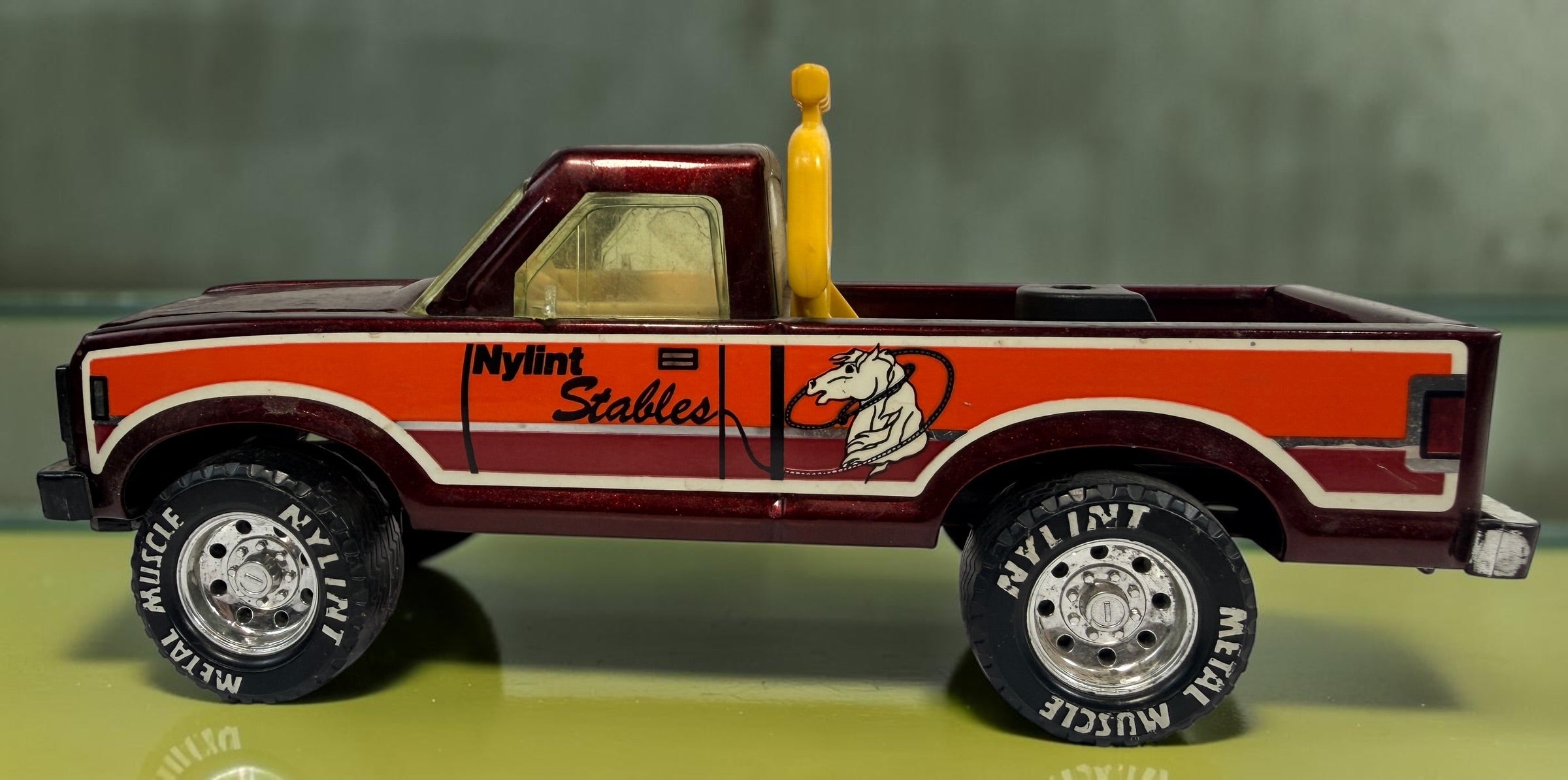 Vintage Nylint Stables Metal Muscle pressed-steel pickup truck, made in Rockford, Illinois, USA. Classic 1980s collectible toy with horse graphics.