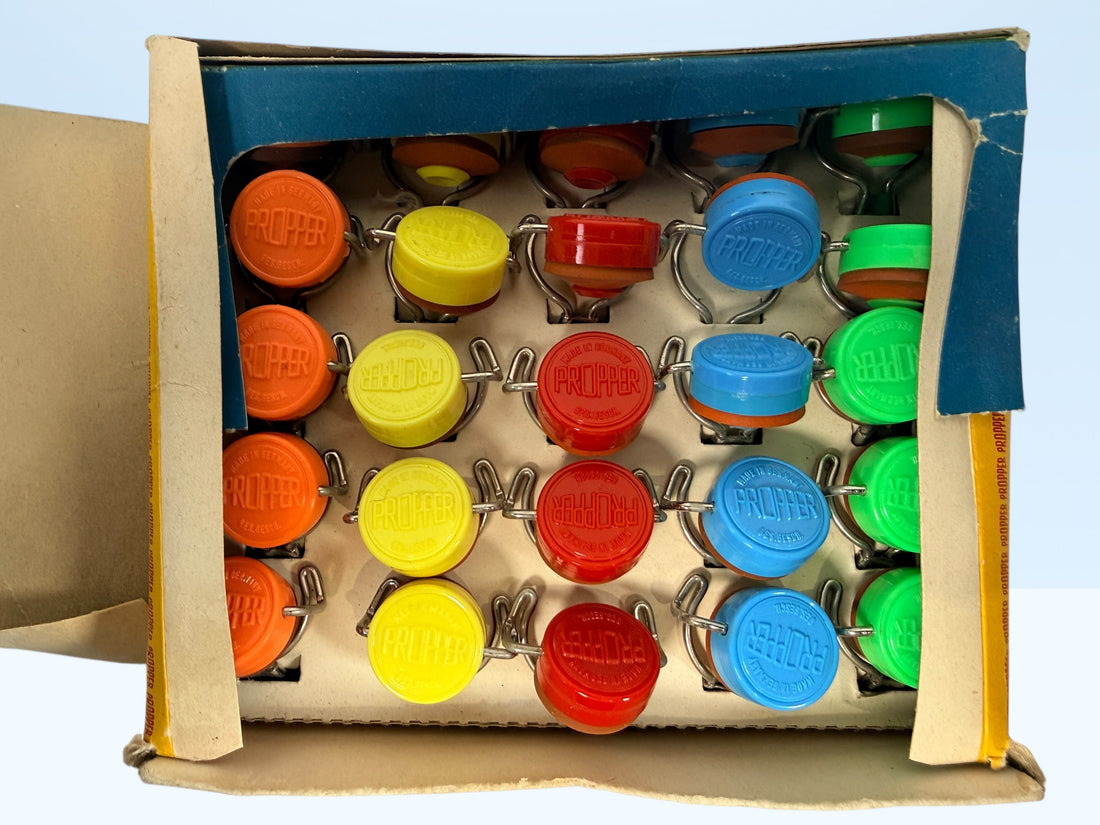 Vintage Propper swing top bottle stoppers set with original box. Retro barware bottle caps for homebrew, soda bottles, or collectible mid-century packaging.