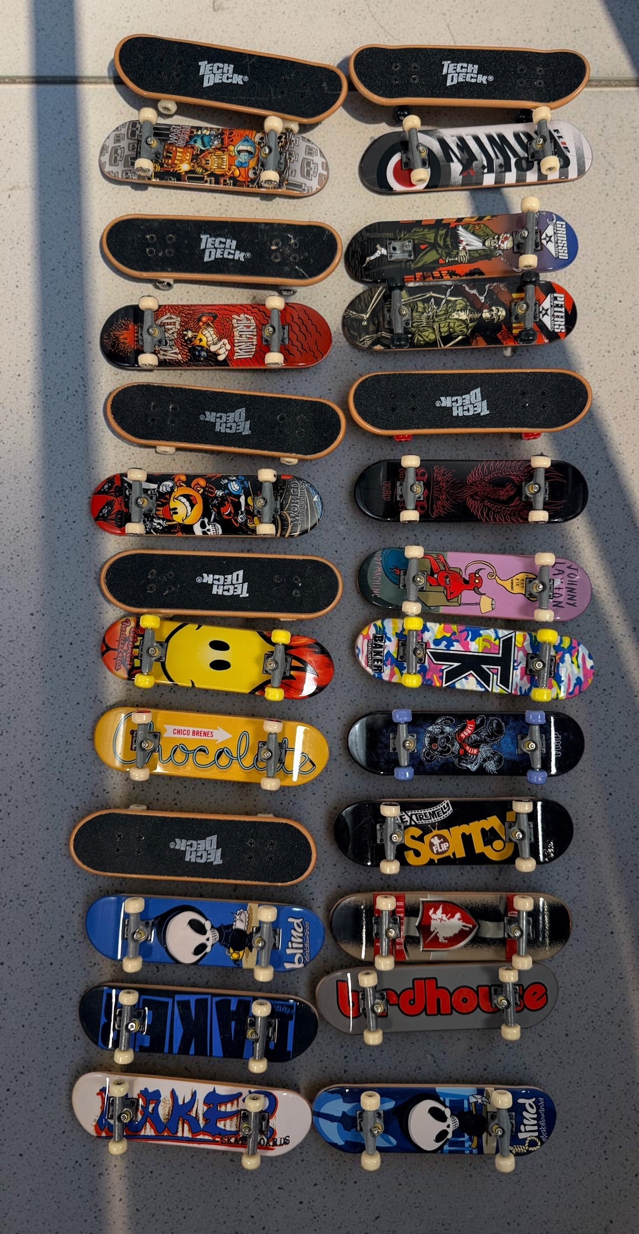 Vintage Tech Deck fingerboard collection with Blind, Flip, Baker, Chocolate, Birdhouse, World Industries boards, spare wheels, parts and tools.