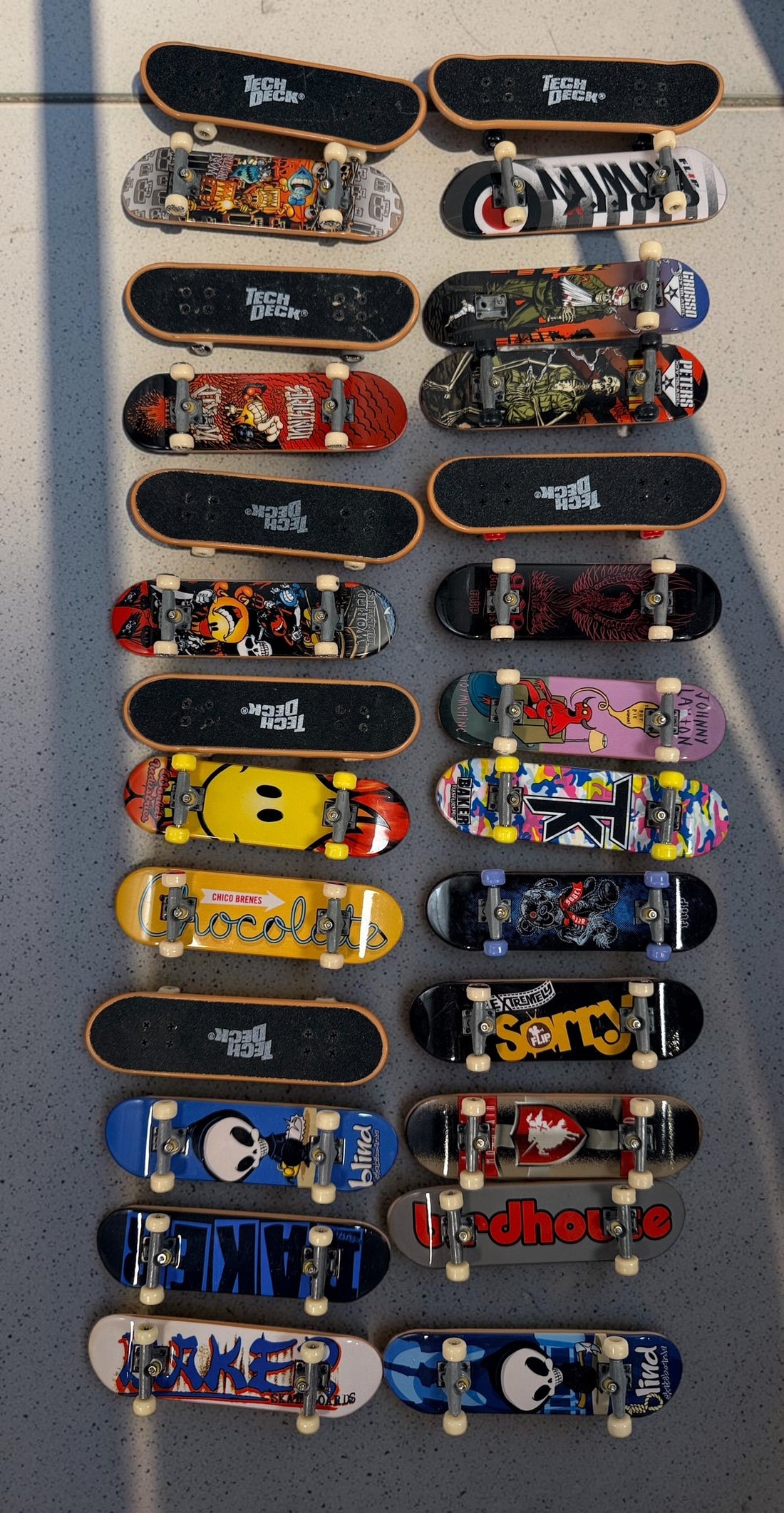 Vintage Tech Deck fingerboard collection with Blind, Flip, Baker, Chocolate, Birdhouse, World Industries boards, spare wheels, parts and tools.
