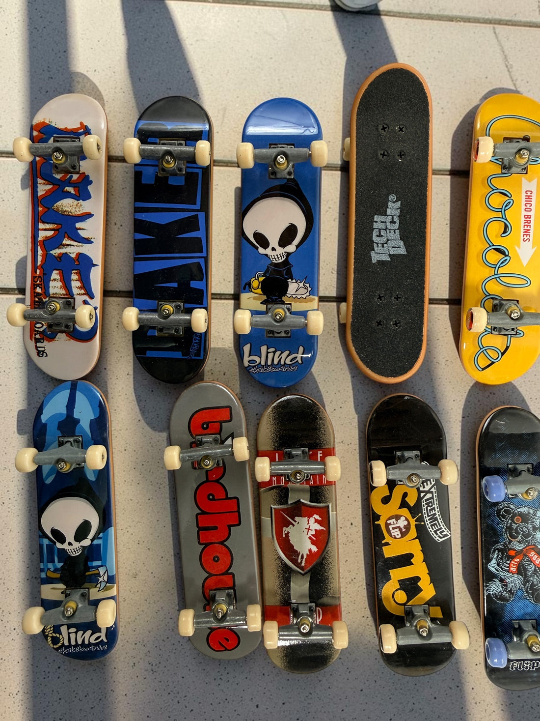 Vintage Tech Deck fingerboard collection with Blind, Flip, Baker, Chocolate, Birdhouse, World Industries boards, spare wheels, parts and tools.