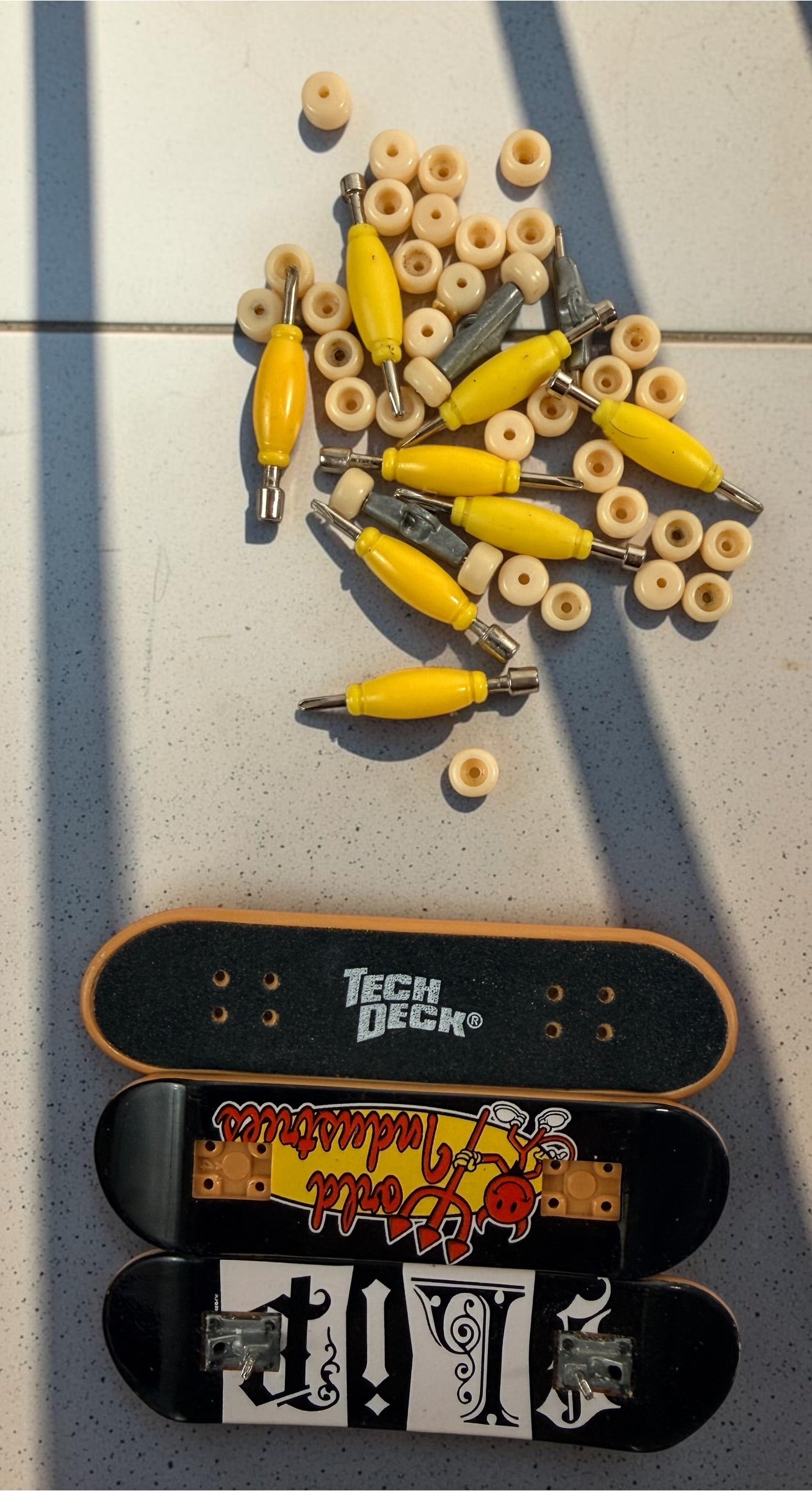Vintage Tech Deck fingerboard collection with Blind, Flip, Baker, Chocolate, Birdhouse, World Industries boards, spare wheels, parts and tools.