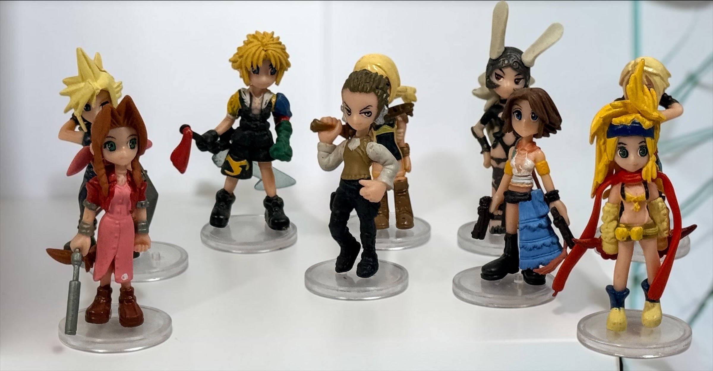 Final Fantasy lot of 10 miniature character figures with clear display stands, including Cloud and Aerith. Pre-owned collectible gaming figures.