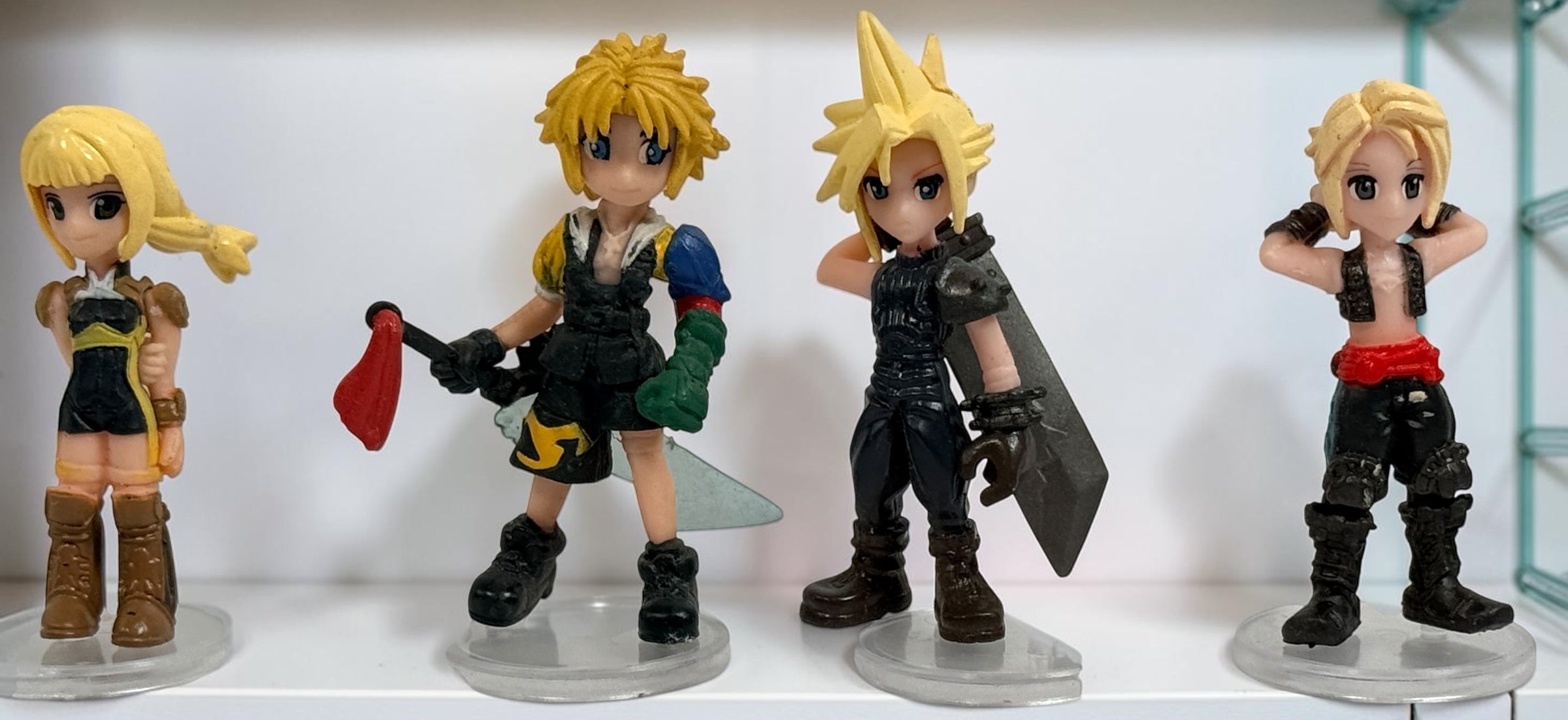 Final Fantasy lot of 10 miniature character figures with clear display stands, including Cloud and Aerith. Pre-owned collectible gaming figures.
