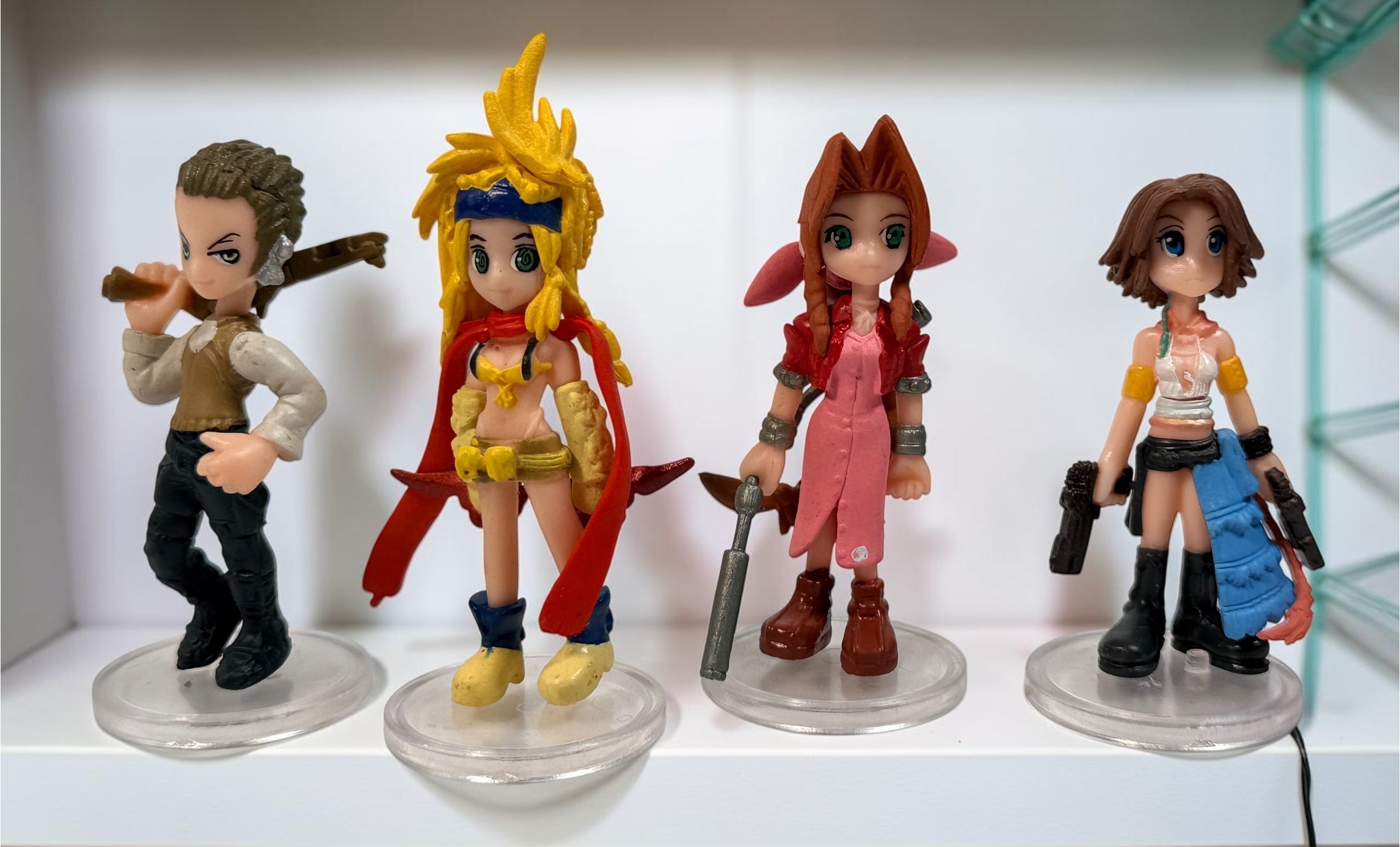 Final Fantasy lot of 10 miniature character figures with clear display stands, including Cloud and Aerith. Pre-owned collectible gaming figures.