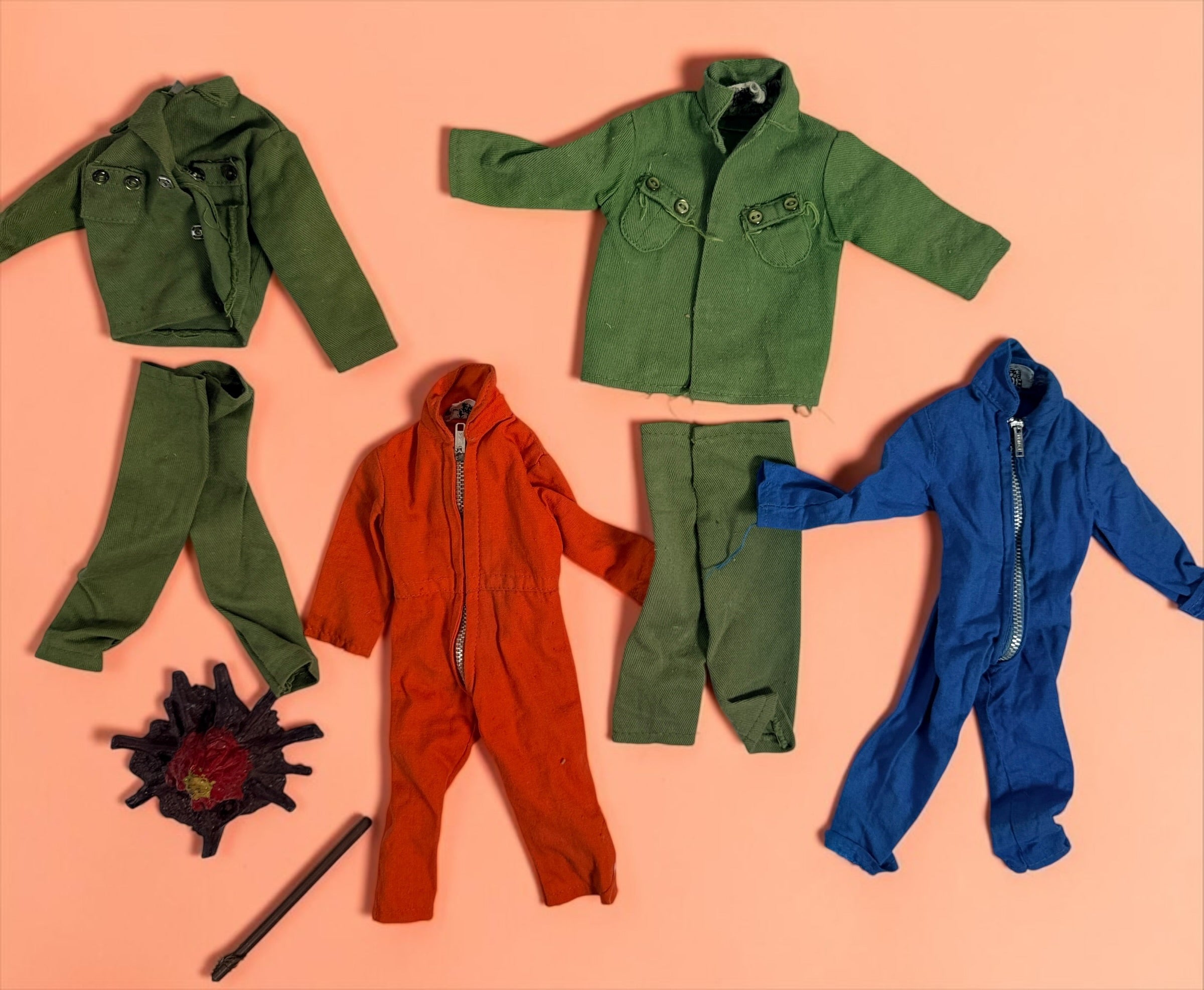 Vintage Hasbro G.I. Joe 12-inch clothing and accessory lot with Hong Kong tags, military uniforms, flight suits and campfire accessory. Original vintage pieces.