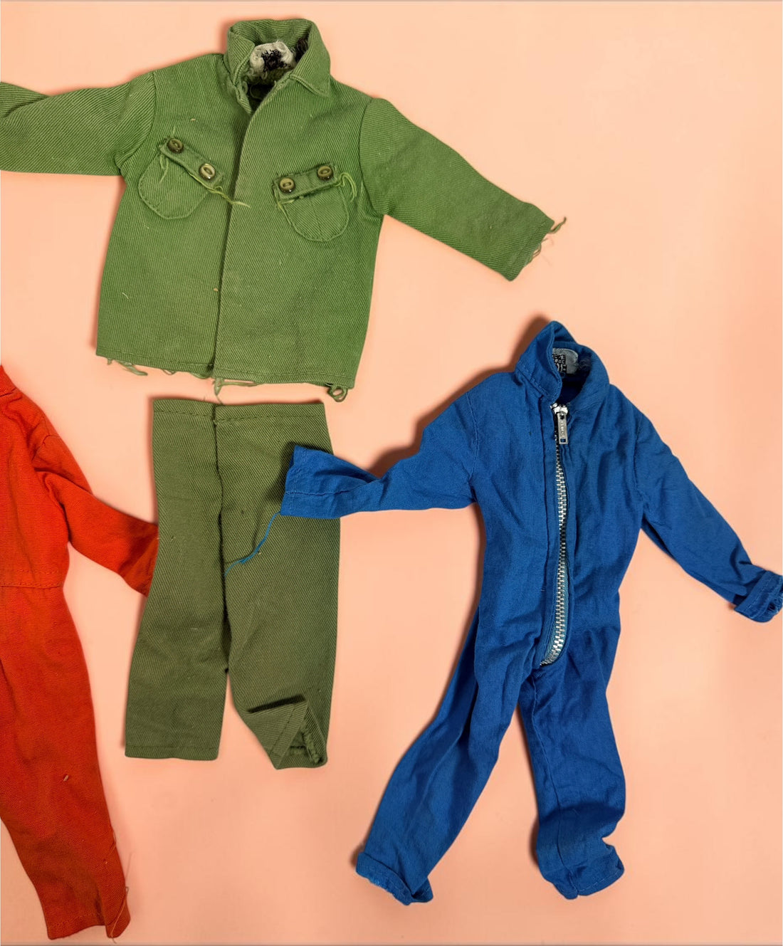 Vintage Hasbro G.I. Joe 12-inch clothing and accessory lot with Hong Kong tags, military uniforms, flight suits and campfire accessory. Original vintage pieces.