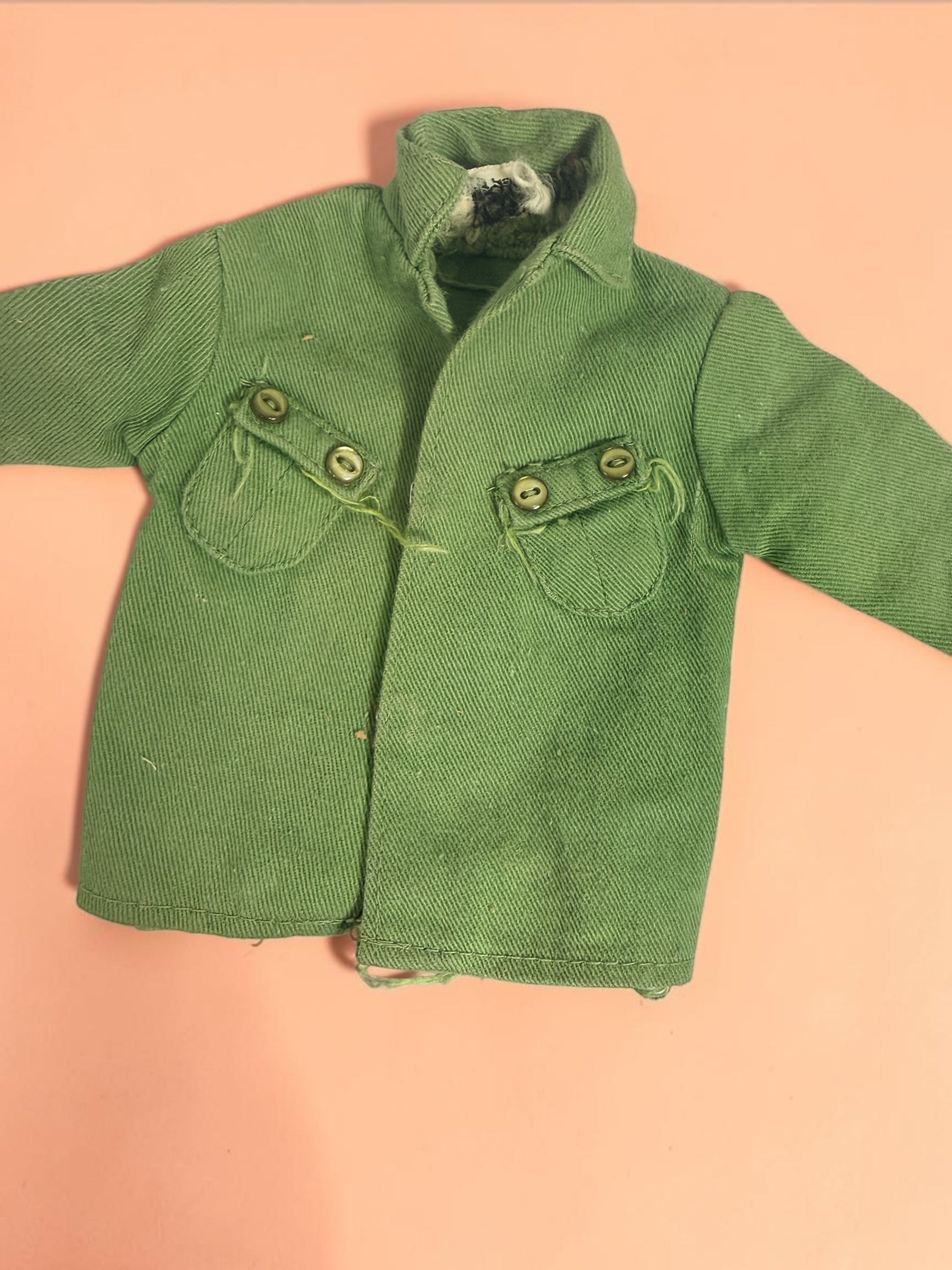 Vintage Hasbro G.I. Joe 12-inch clothing and accessory lot with Hong Kong tags, military uniforms, flight suits and campfire accessory. Original vintage pieces.