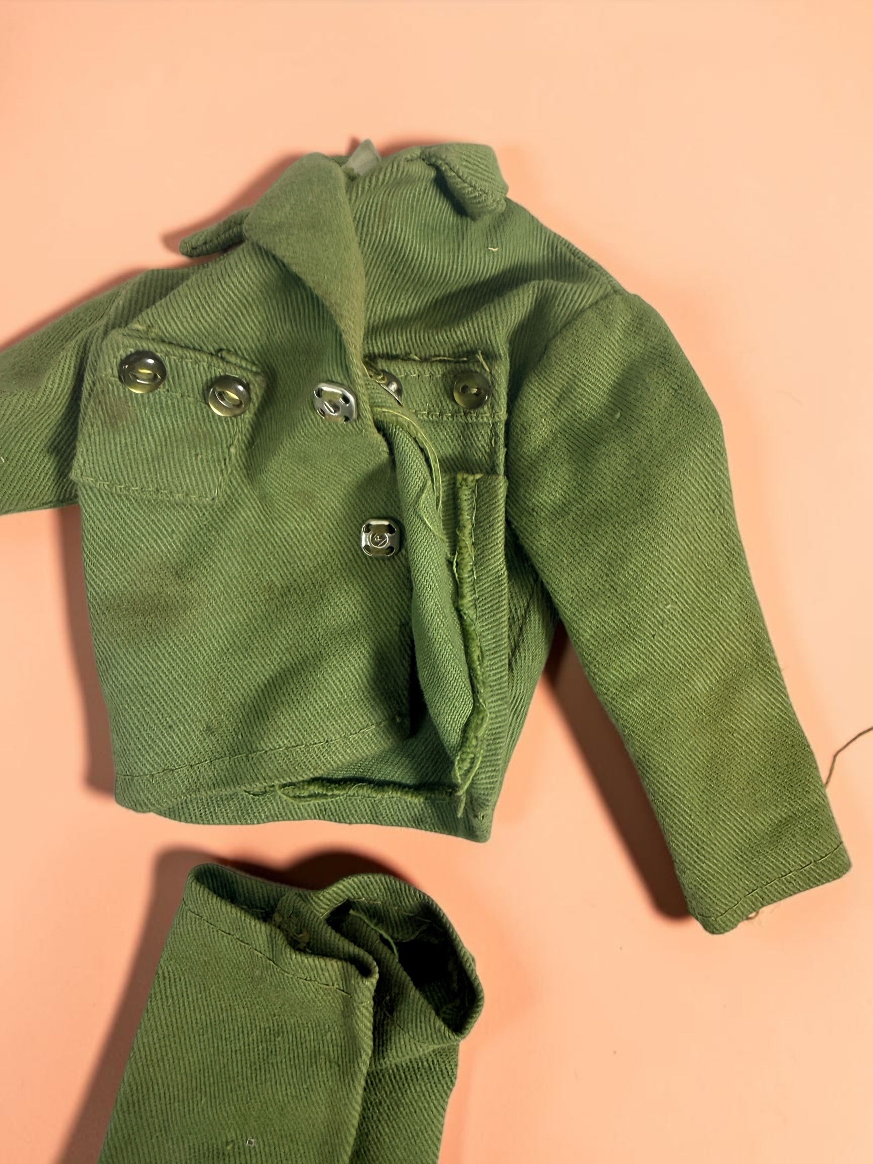 Vintage Hasbro G.I. Joe 12-inch clothing and accessory lot with Hong Kong tags, military uniforms, flight suits and campfire accessory. Original vintage pieces.