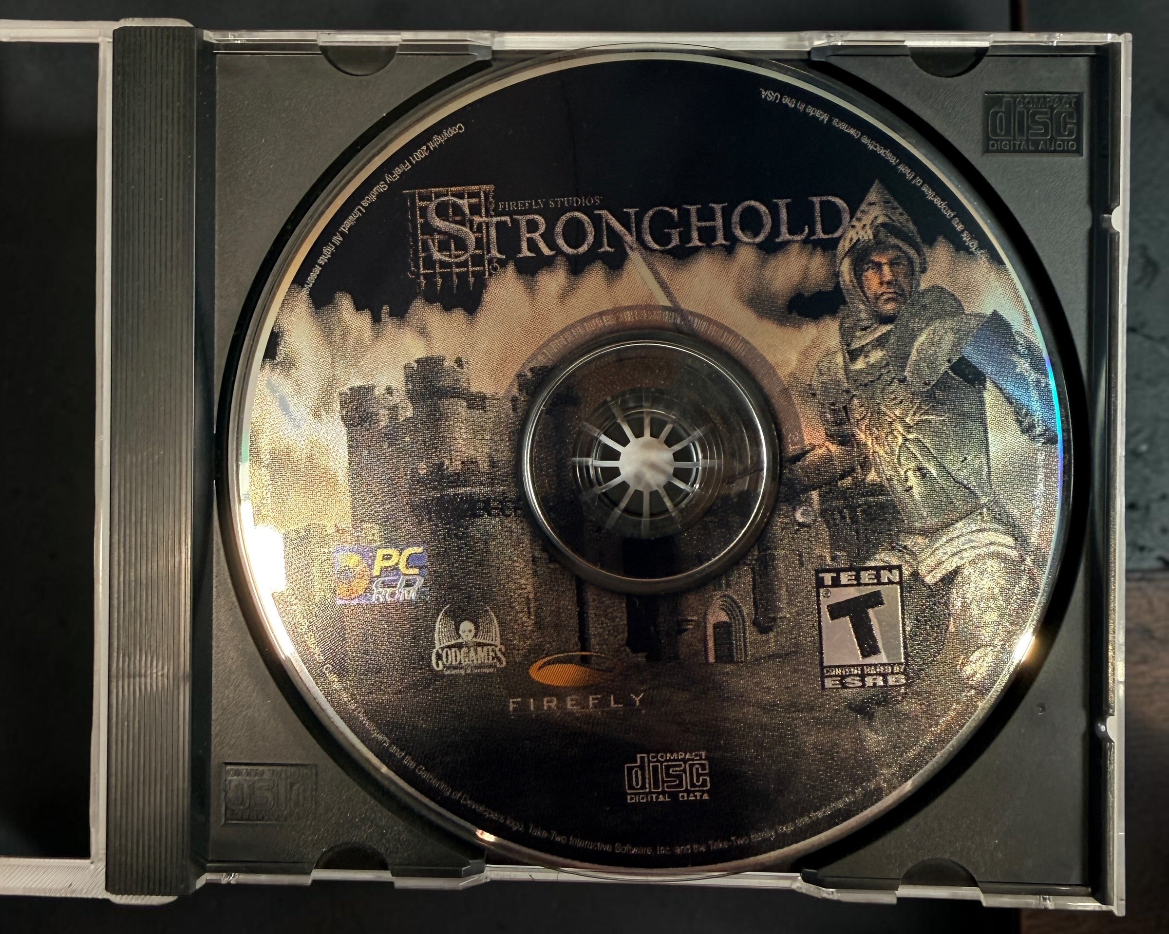 Stronghold PC 2001 original Firefly Studios big-box edition with CD-ROM and manual. Classic medieval castle-building strategy game.