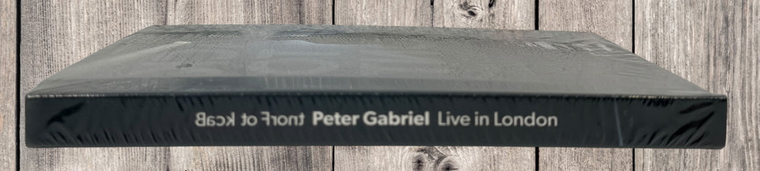 Sealed deluxe edition of Peter Gabriel Back to Front Live in London. Hardbound concert book format with multi-disc content. Collector-grade condition.