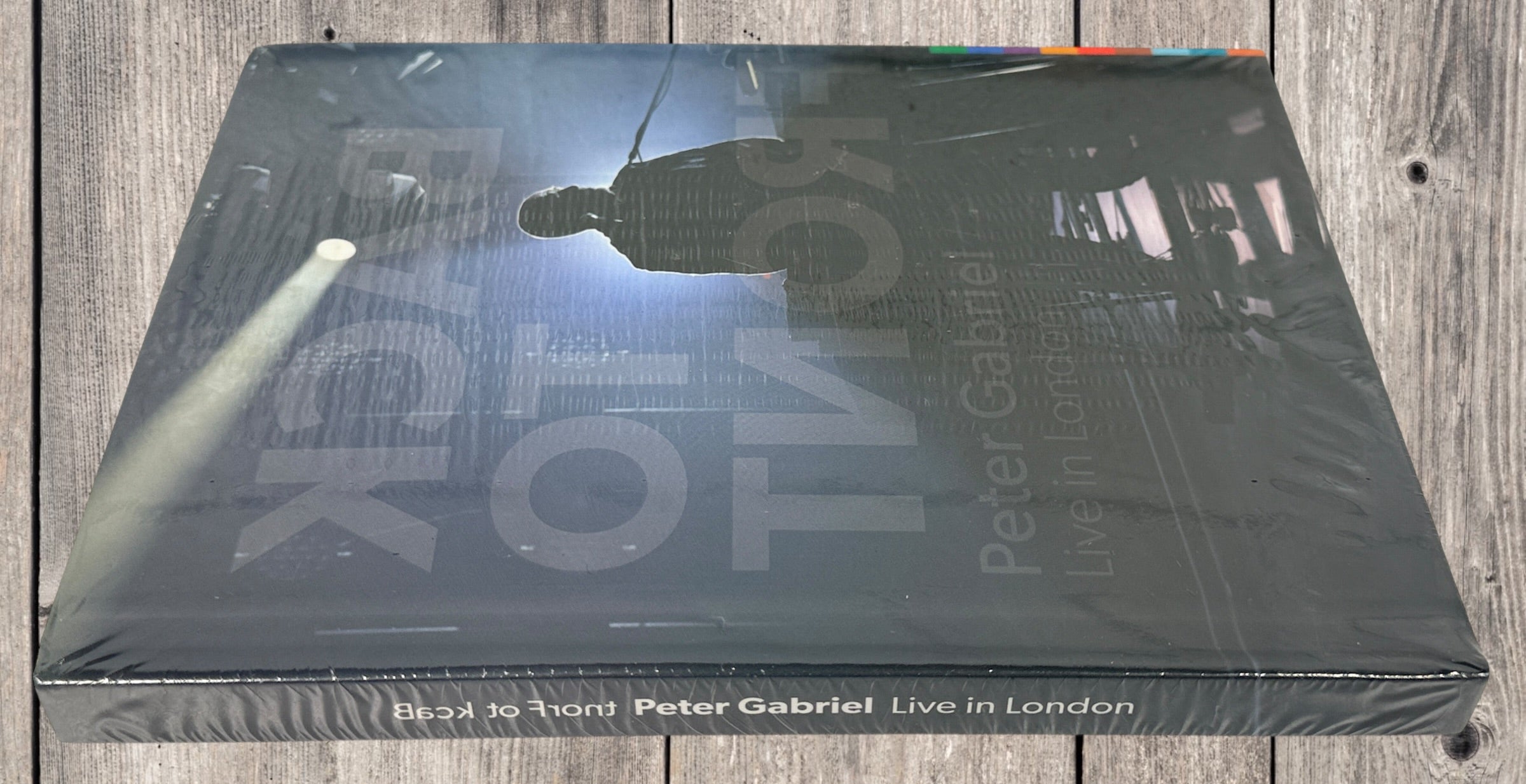 Sealed deluxe edition of Peter Gabriel Back to Front Live in London. Hardbound concert book format with multi-disc content. Collector-grade condition.