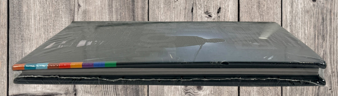 Sealed deluxe edition of Peter Gabriel Back to Front Live in London. Hardbound concert book format with multi-disc content. Collector-grade condition.