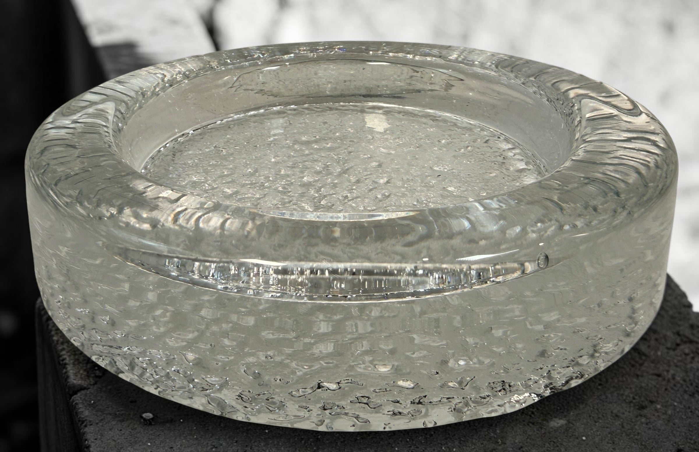 Vintage Iittala Visa clear glass ashtray designed by Timo Sarpaneva in Finland. Sculptural Scandinavian modern art glass with ice-textured finish.