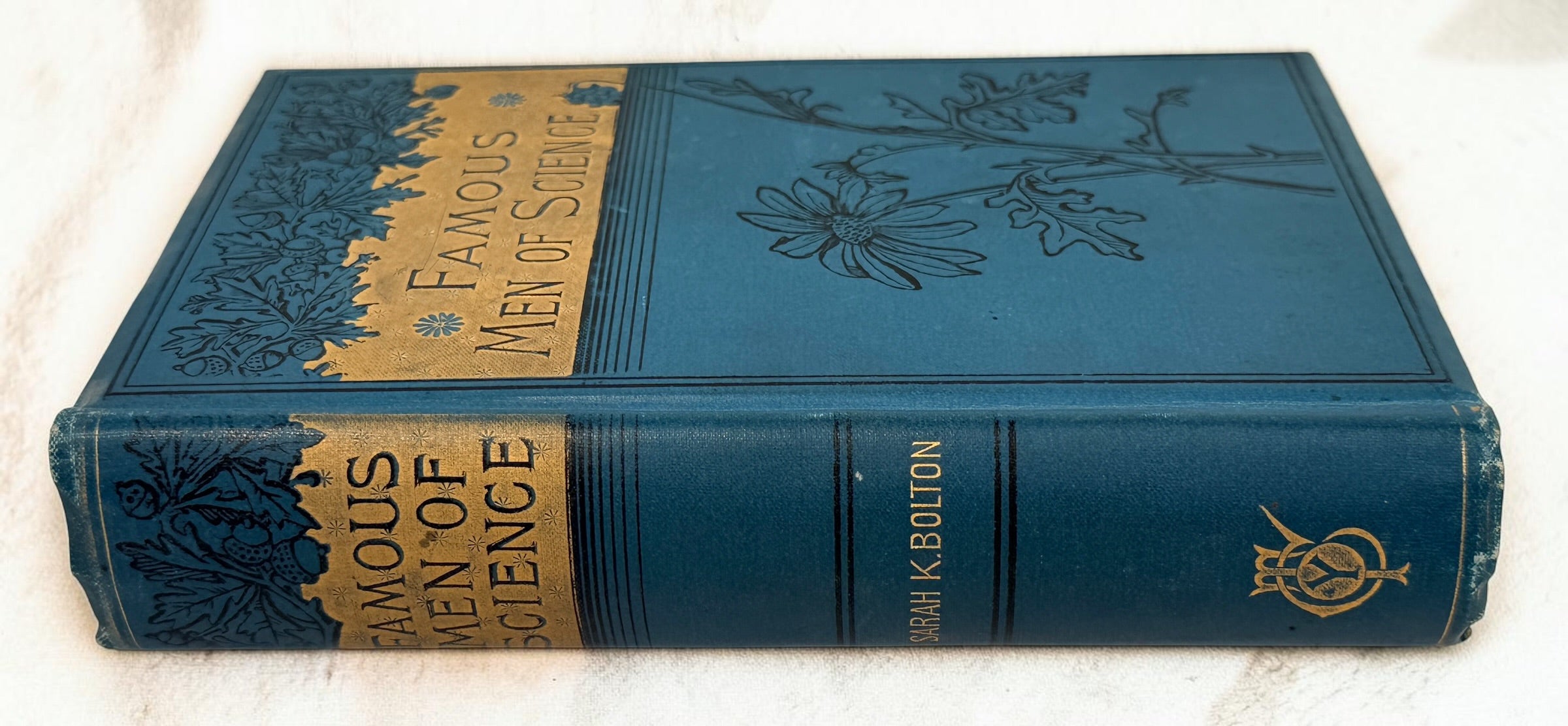 1889 first edition of Famous Men of Science by Sarah K. Bolton, illustrated antique hardcover with decorative blue cloth and gilt binding.