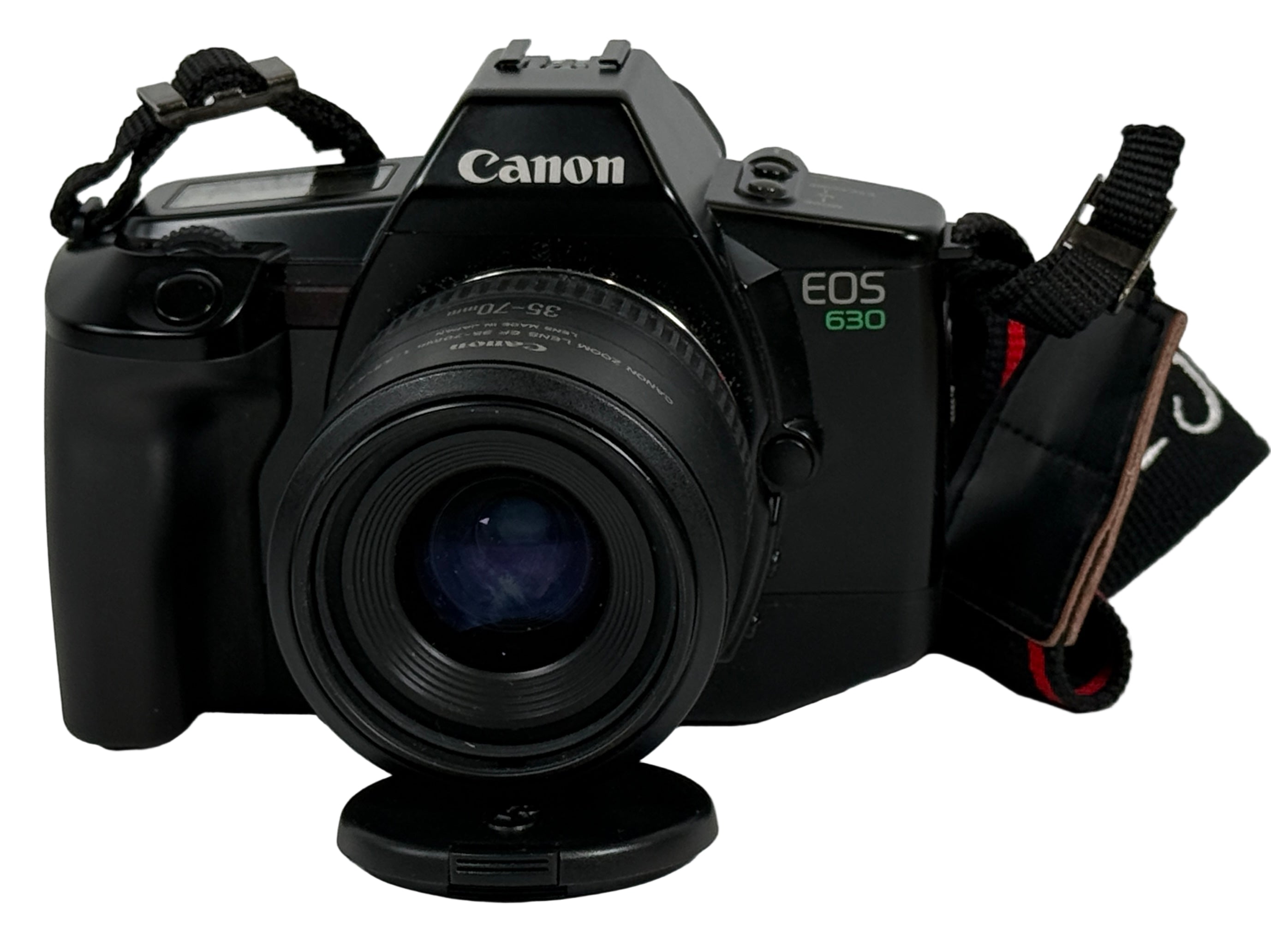 Canon EOS 630 camera on a white surface with a blurred background