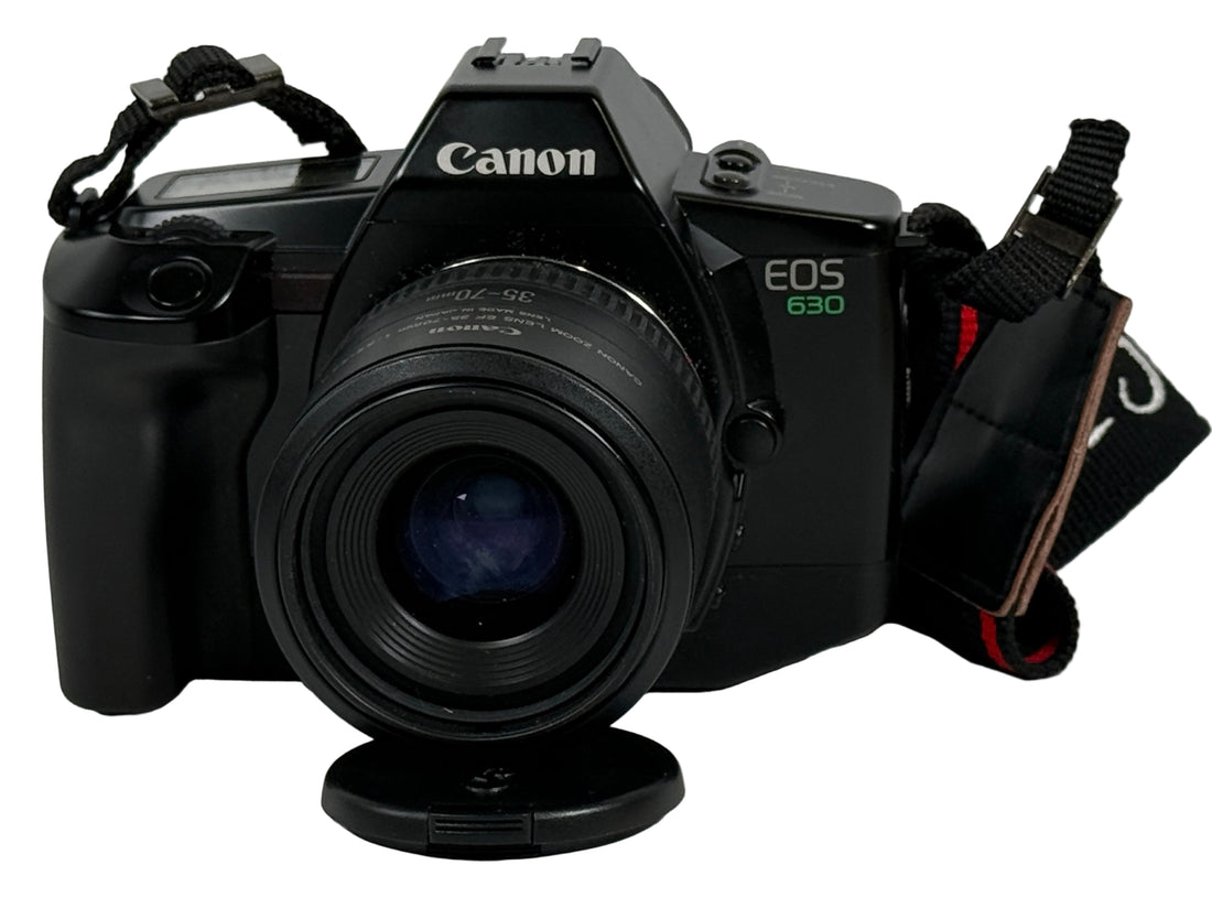 Canon EOS 630 camera on a white surface with a blurred background