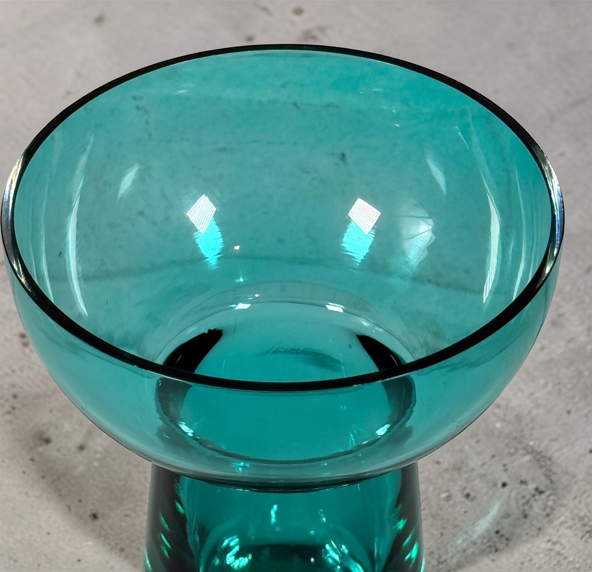 Mid century modern teal art glass pedestal bowl with heavy clear base. Scandinavian style decorative centerpiece perfect for modern or vintage interiors.