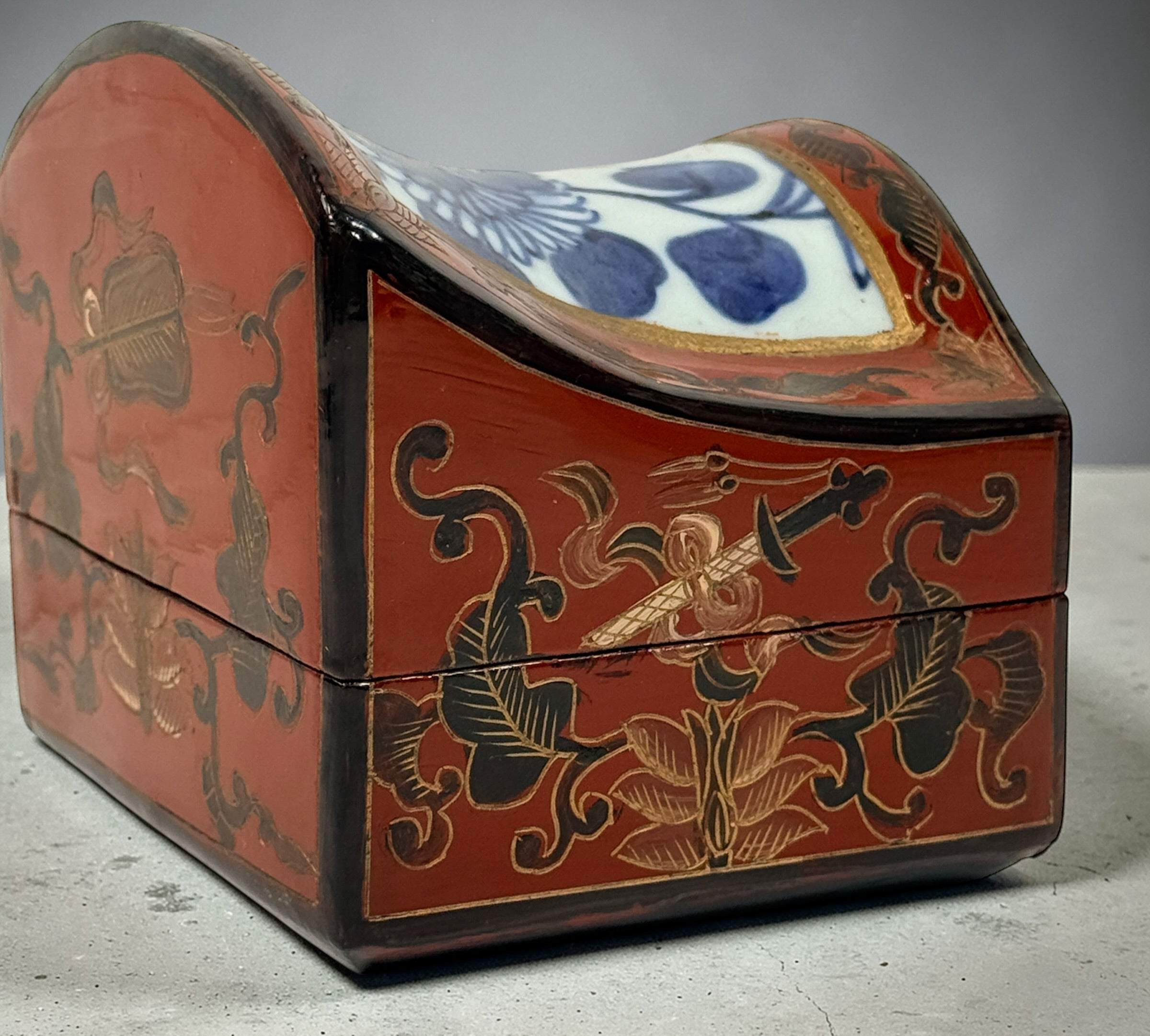 Chinese lacquer jewelry box with porcelain floral panel, red and gold decorative trinket box, vintage Asian decor storage piece, elegant display accent.