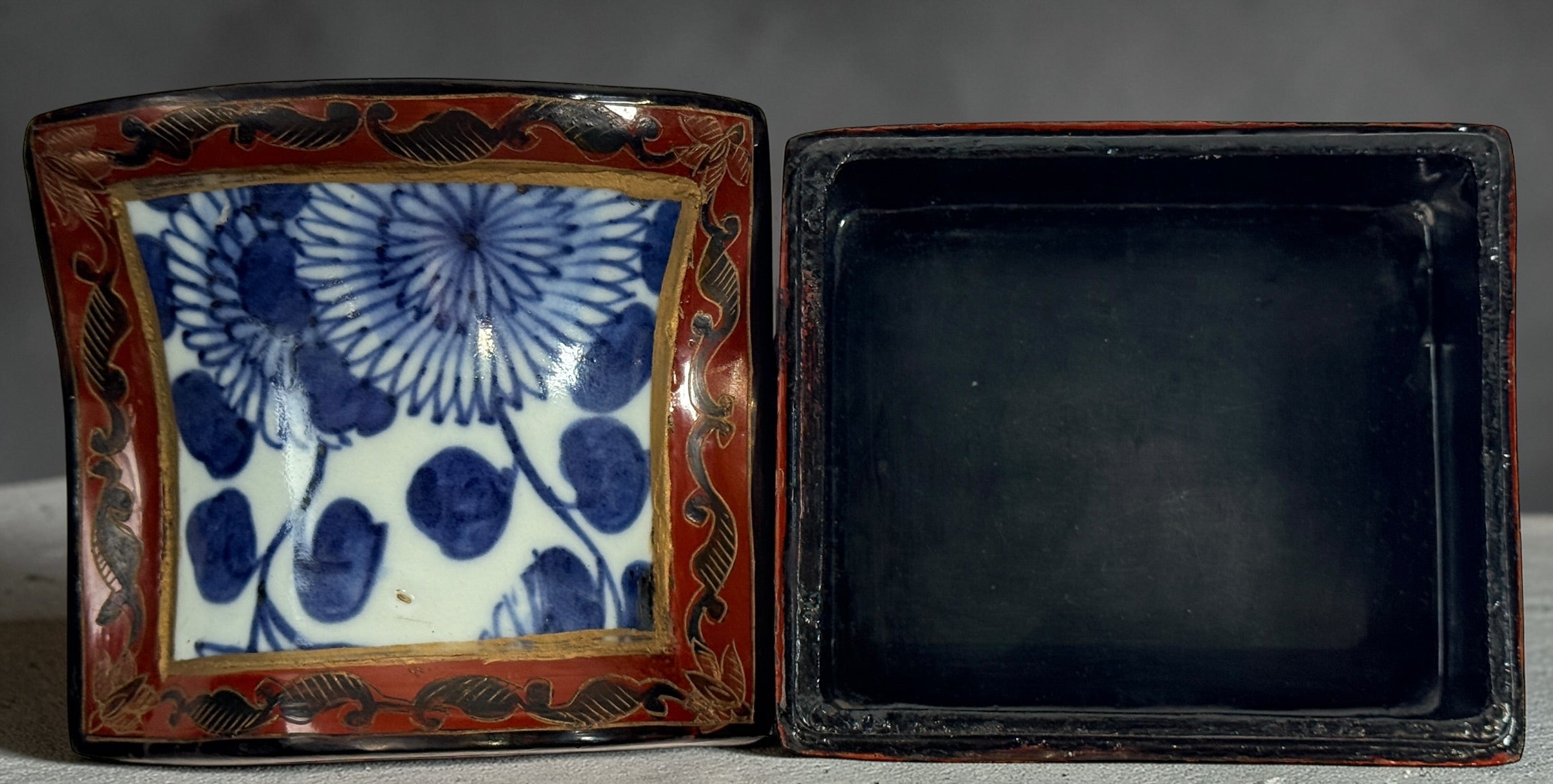 Chinese lacquer jewelry box with porcelain floral panel, red and gold decorative trinket box, vintage Asian decor storage piece, elegant display accent.