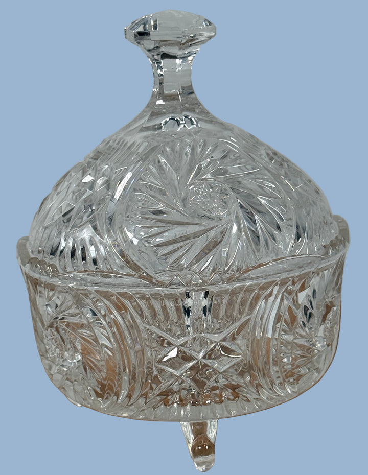Decorative crystal dish with lid on a wooden surface