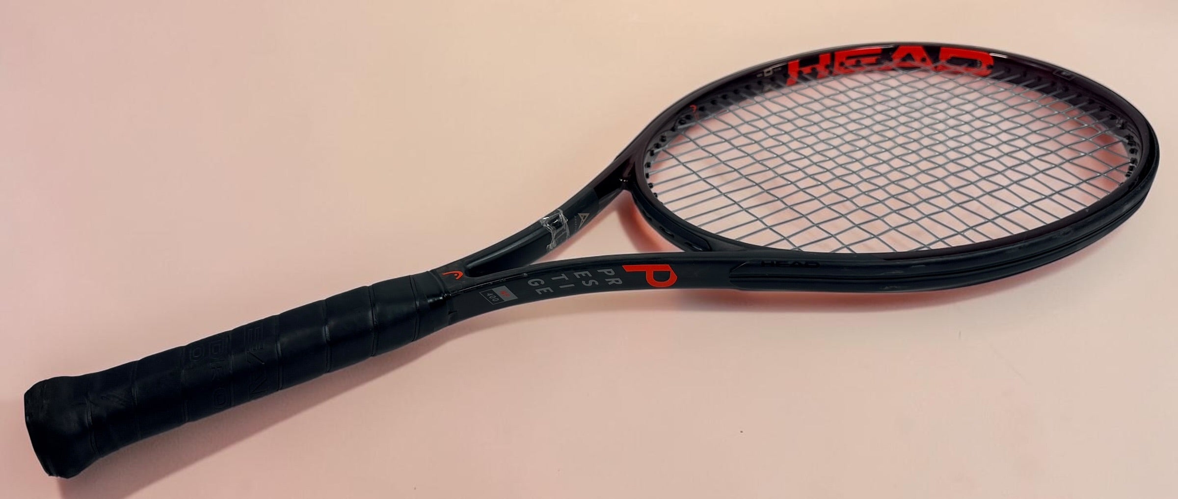 HEAD Prestige MP tennis racquet with Auxetic technology. Pre-owned and strung with visible cosmetic wear. Premium control racquet for experienced players.