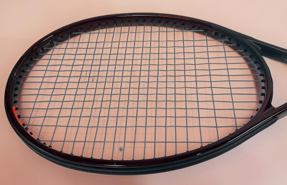 HEAD Prestige MP tennis racquet with Auxetic technology. Pre-owned and strung with visible cosmetic wear. Premium control racquet for experienced players.