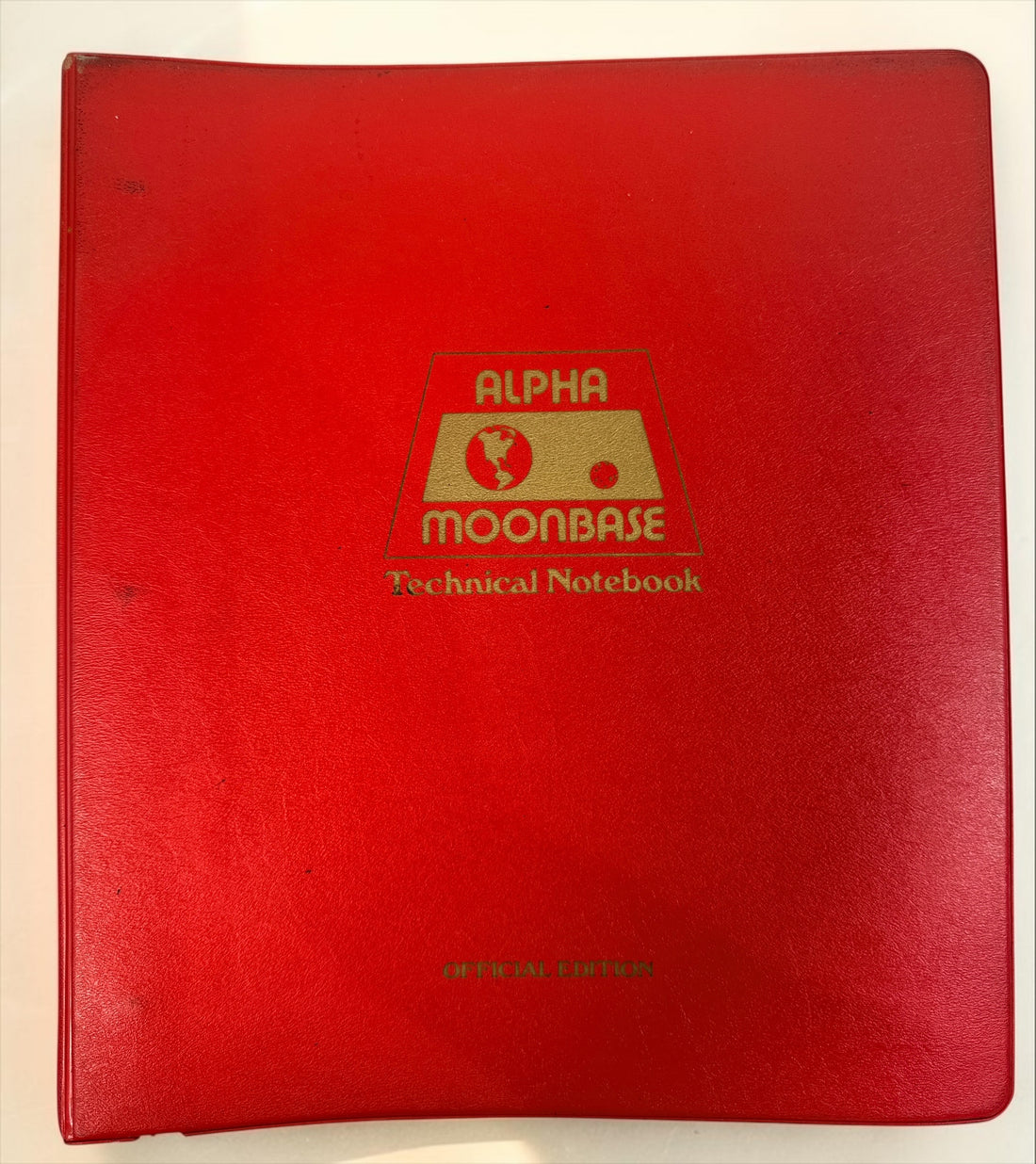 1977 Space: 1999 Moonbase Alpha Technical Notebook, first printing by Starlog. Illustrated vintage reference in red binder. See condition and completeness notes.