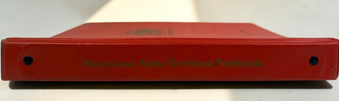 1977 Space: 1999 Moonbase Alpha Technical Notebook, first printing by Starlog. Illustrated vintage reference in red binder. See condition and completeness notes.