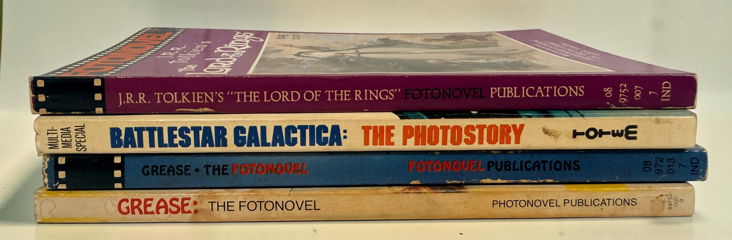 Vintage 1978–79 Fotonovel lot with Lord of the Rings, Battlestar Galactica and two Grease editions. Four collectible movie photobooks.