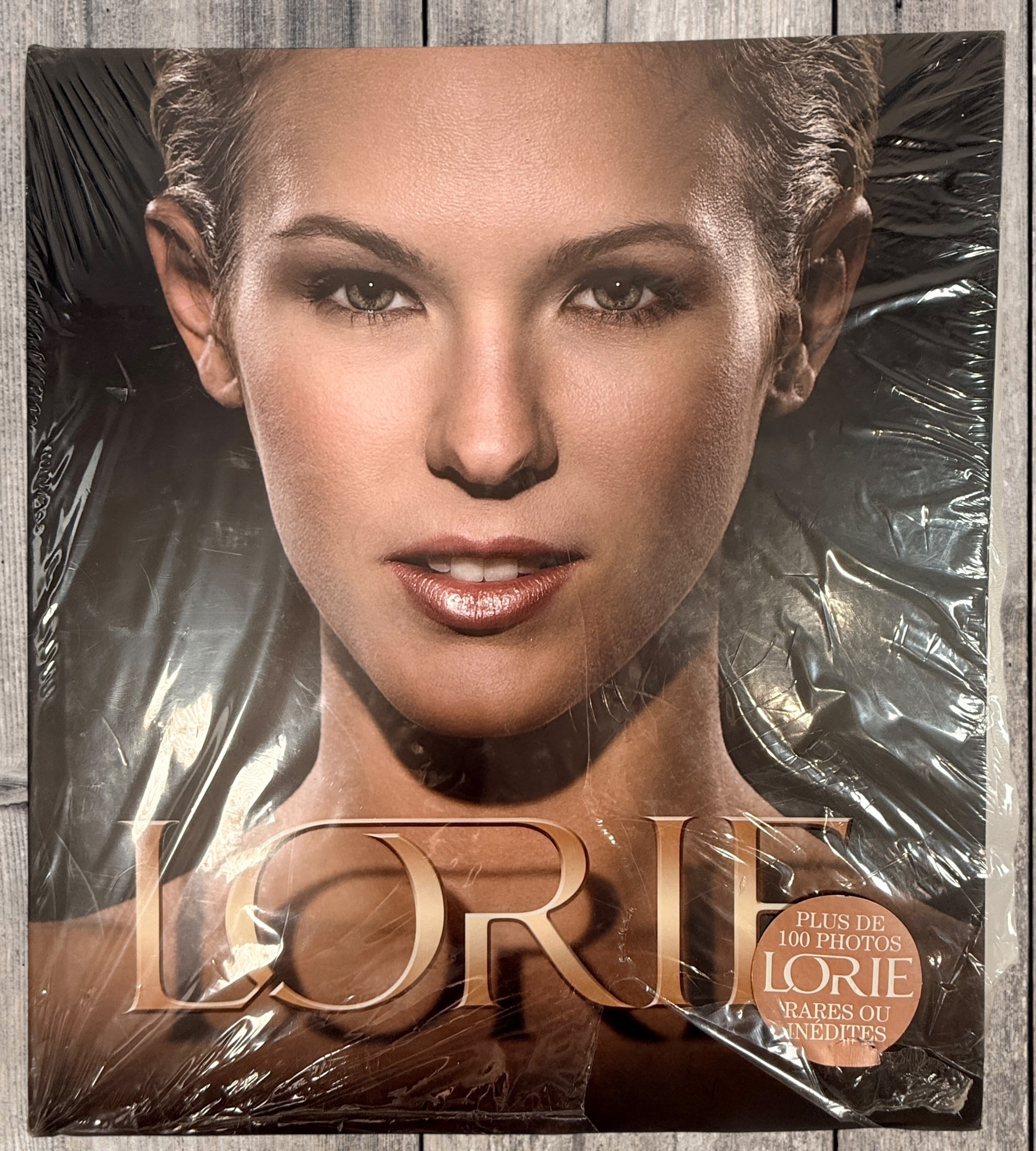 Sealed Lorie hardcover photo book featuring 100+ rare and unpublished images. Large-format French pop collector edition in excellent condition.